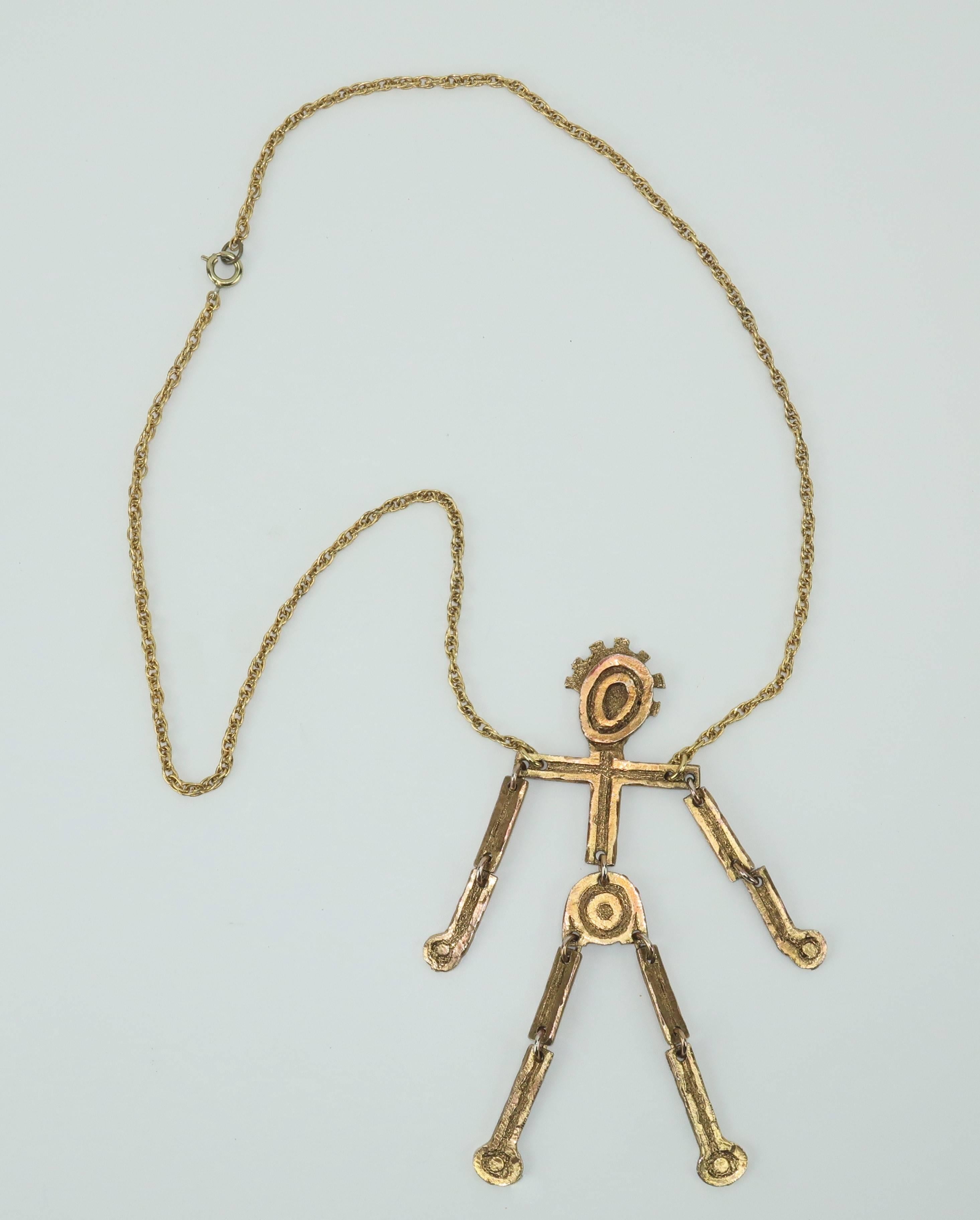 Mr. We is cuttin’ a rug with every move!  This C.1970 articulated man pendant necklace has a brutalist gold tone metal finish mixed with a whimsical style and loads of movement.  His hinged limbs enable him to shimmer and sway while attached to a