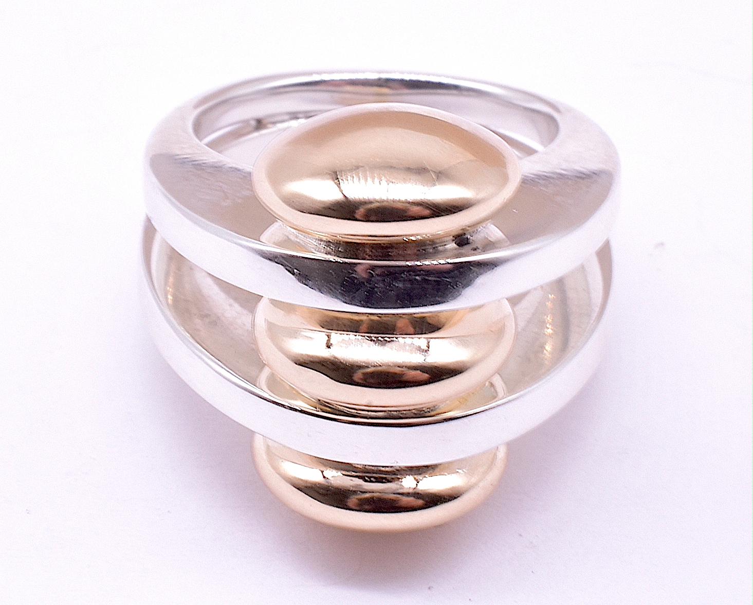 Modernist circles abound on this minimalist ring boldly signed PIERRE CARDIN. Constructed entirely of silver and gold, no matter what other jewelry you are wearing, this ring goes with it all. The ring has three gold half rounds discs on top of,