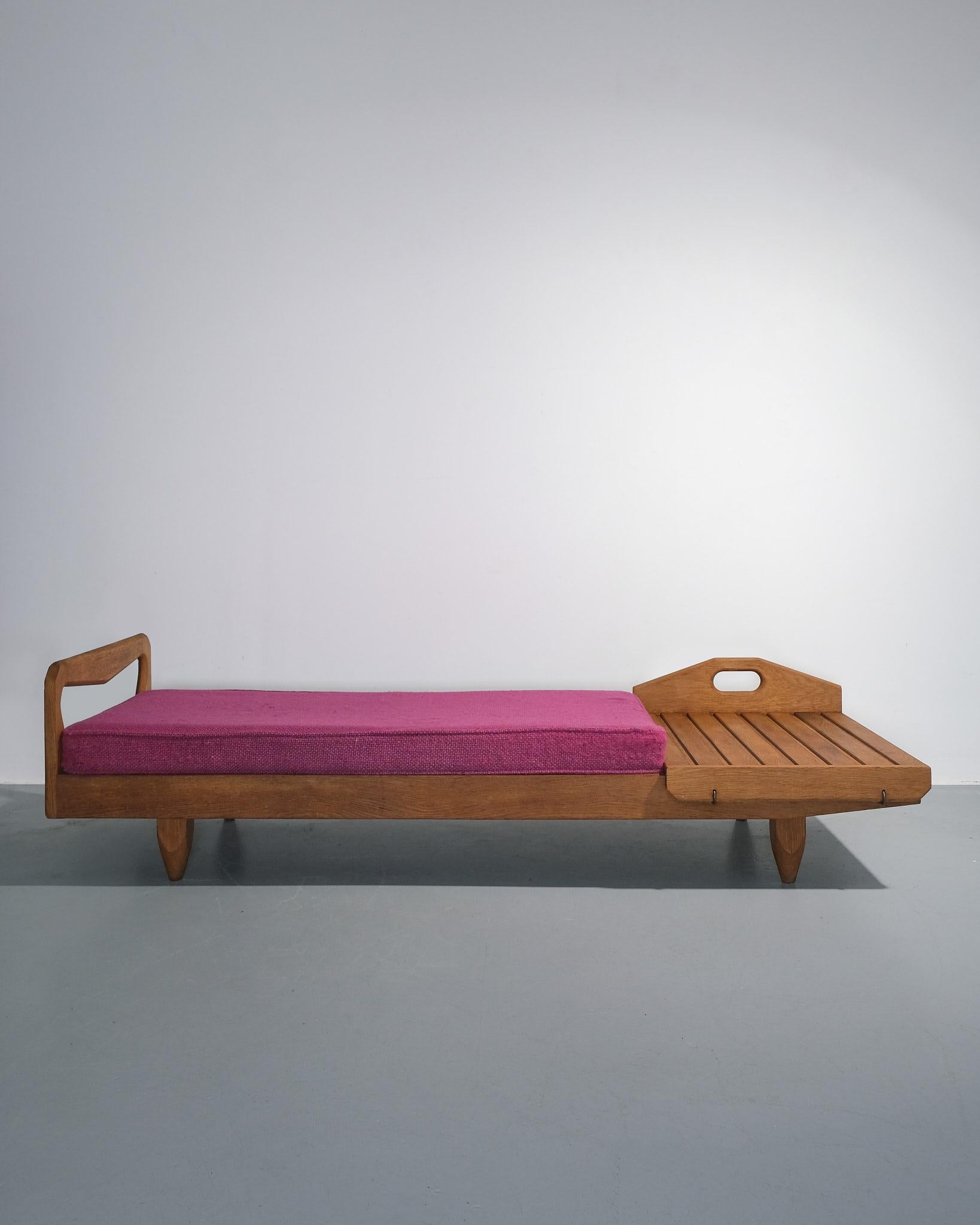 Bel exemple du design français du milieu du siècle, ce canapé/lit de jour bas à rallonge a été créé dans les années 1970 par Guillerme et Chambron pour leur société, Votre Maison. Fabriquée en chêne ciré, cette pièce témoigne de l'alliance de la