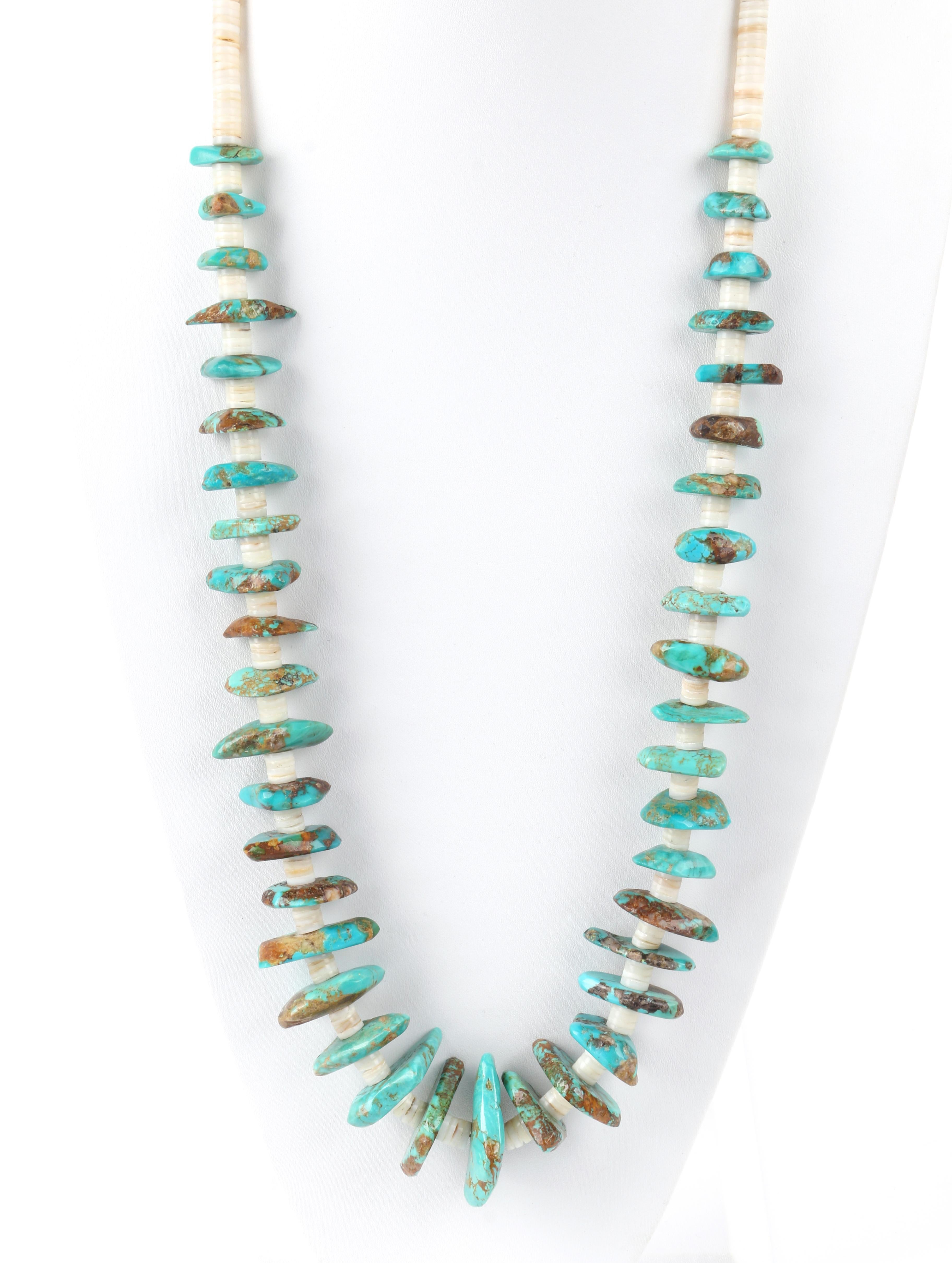 c.1970’s Navajo Turquoise Stone Ivory Pen Shell Heishi Bead Long Strand Necklace
 
Circa: 1970’s 
Style: Beaded necklace
Color(s): Shades of turquoise, brown, tan, and ivory
Unmarked Material (feel of): Turquoise (stones); Pen Shells (disc beads);