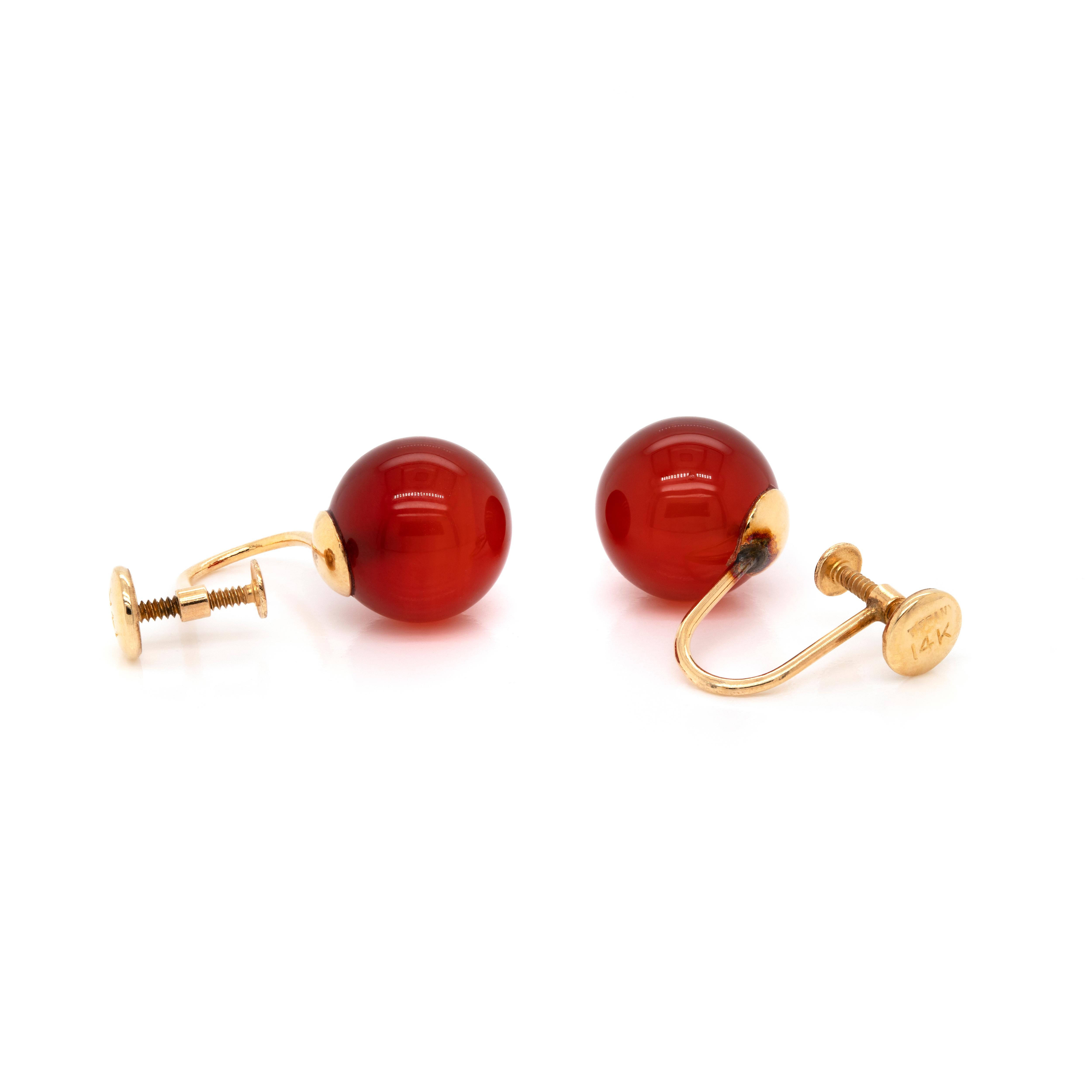 This wonderful vintage set by Tiffany&Co. features a selection of four gemstone crew back stud earrings. The set consists of one onyx, tiger eye, carnelian and lapis lazuli pair of 10mm spheres fitted into 14 carat yellow gold settings. The earrings