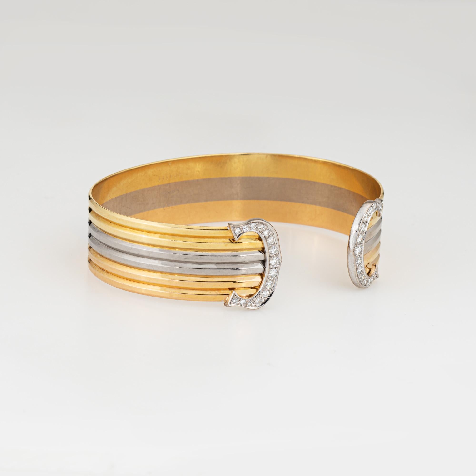 Vintage Cartier 'Double C' cuff bracelet crafted in 18 karat yellow, white & rose gold (circa 1980s).  

From the iconic C de Cartier collection the bracelet is crafted in 18k yellow, rose and white gold with unmistakable diamond set 