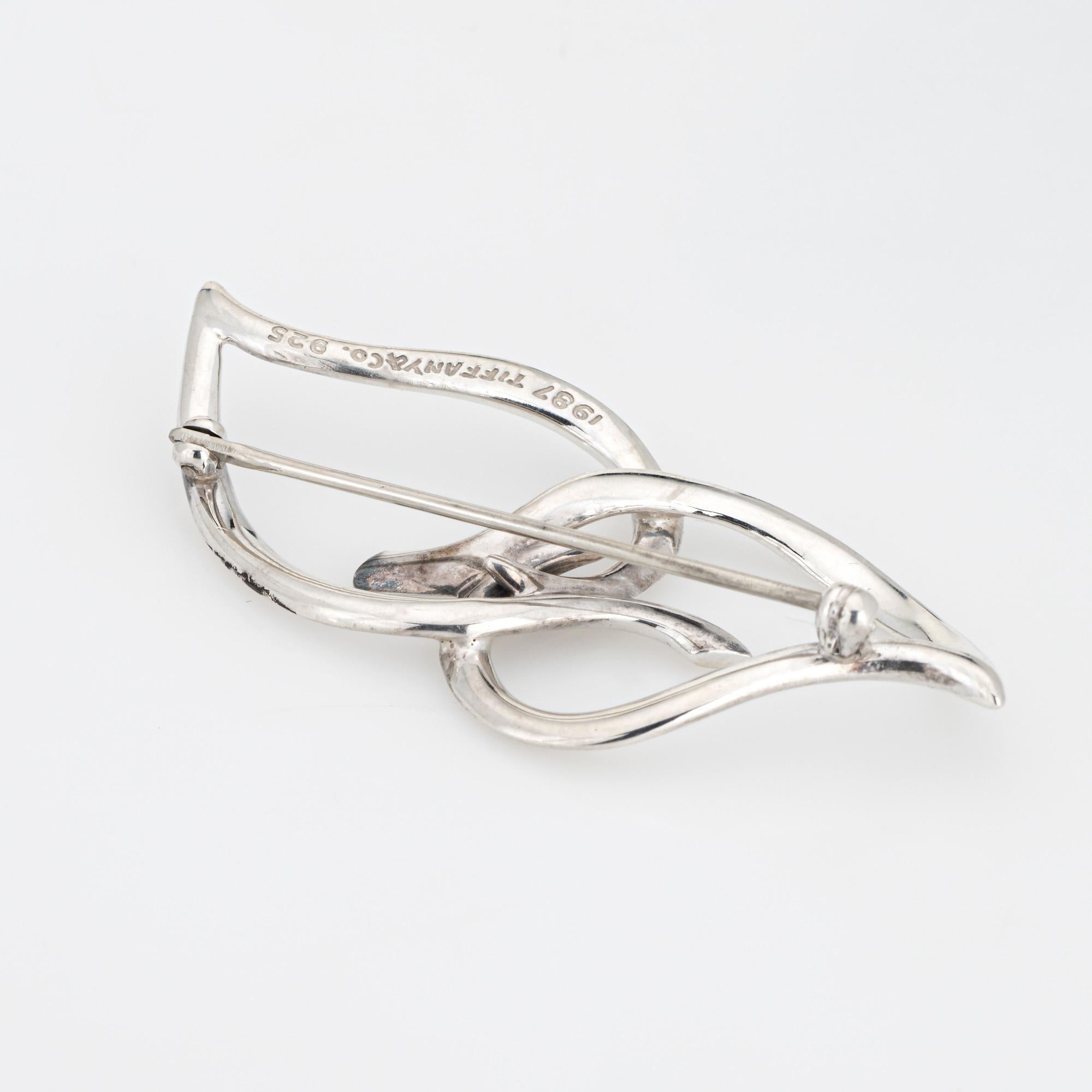 Vintage Tiffany & Co leaf brooch crafted in sterling silver (circa 1987).  

The sculpted design highlights two beautiful stylized leaves. The brooch is a great statement piece to add a unique look to a lapel, cuff, or dress. The retired piece makes