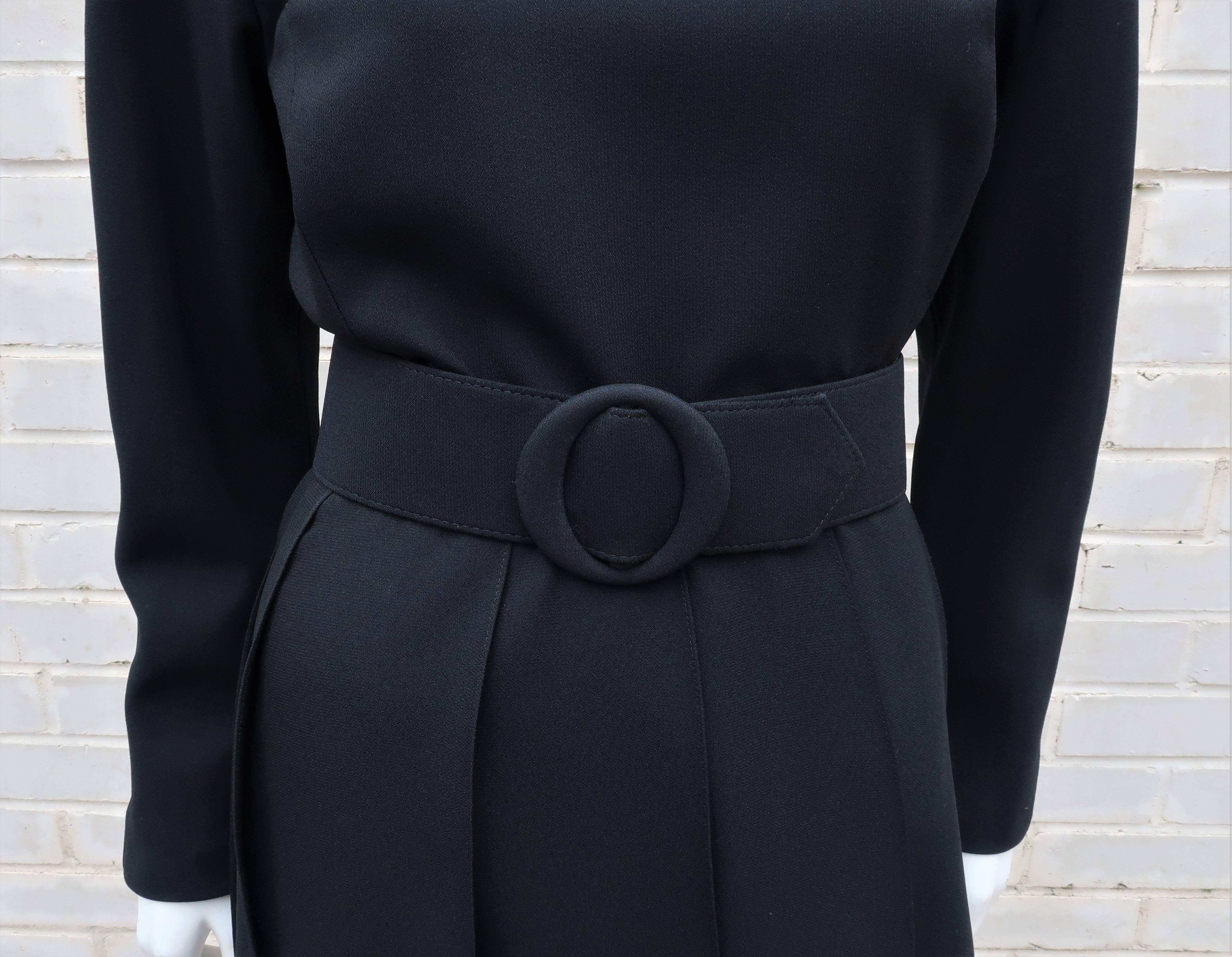 At first glance this may look like a simple 'little black dress' but leave it to Arnold Scaasi to make minimalist look anything but simple.  The polyester crepe dress looks and feels like silk with zipper and hooks at the back.  The blousy bodice