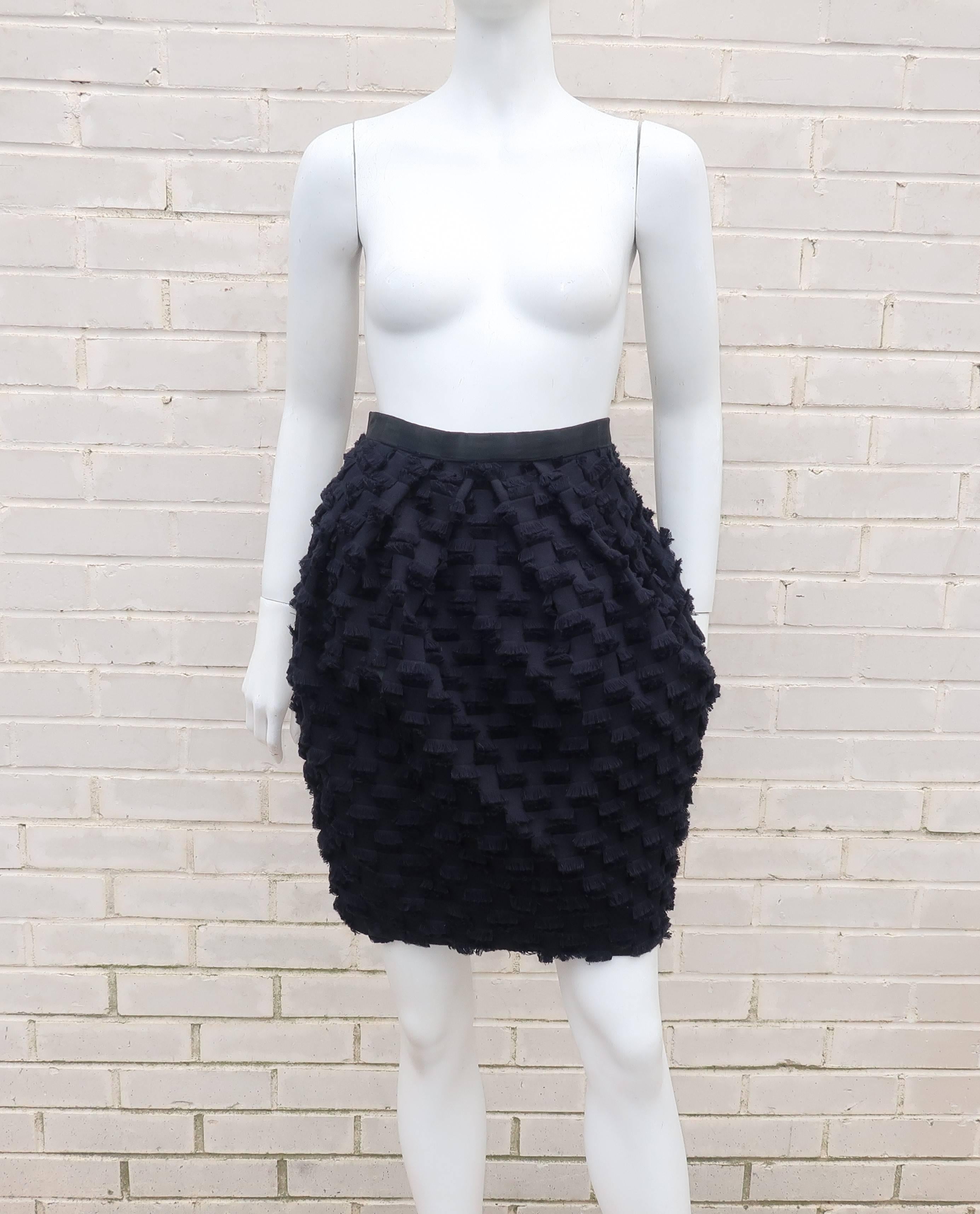 This Saks Fifth Avenue bubble skirt is a tactile delight.  The black fabric is a patchwork blend of a casual weight cotton and dressier satin with allover eyelash style fringe.  It zips and hooks at the back with inverted pleats at the front