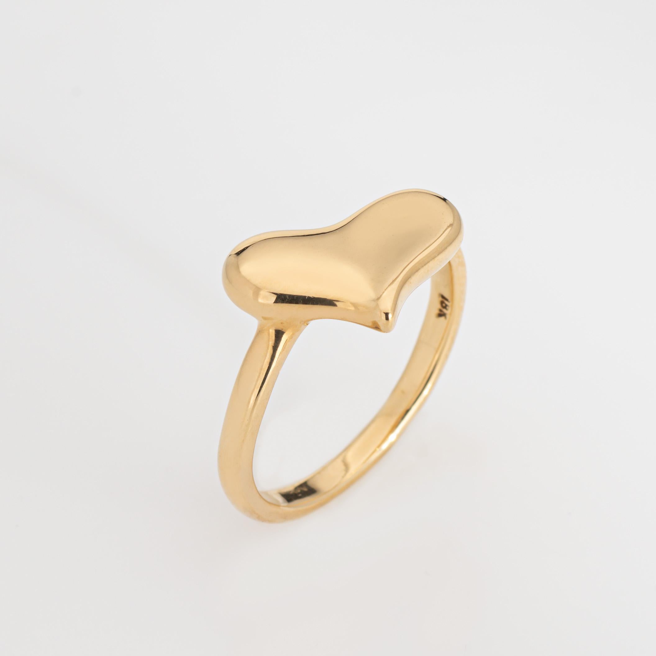 Vintage Angela Cummings heart ring crafted in 18 karat yellow gold (circa 1992).  

The whimsical heart is designed in a slightly off-center position. The iconic designer worked for Tiffany & Co for 18 years, branching away in 1992 to start her own