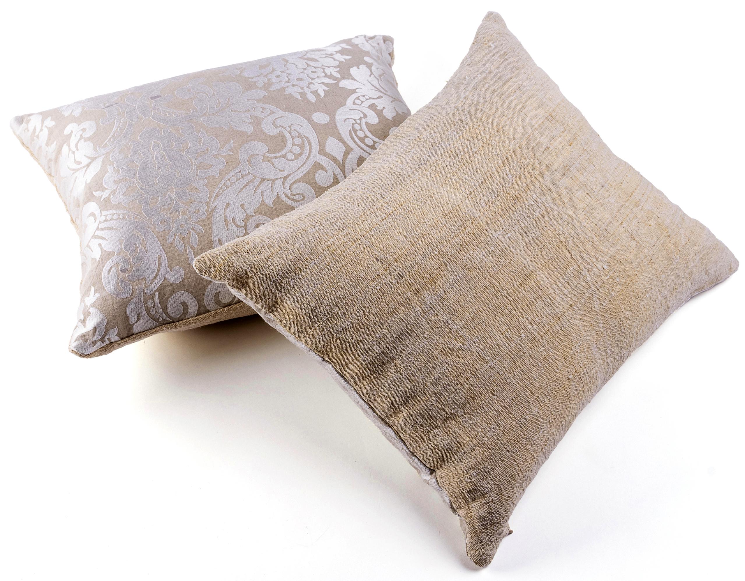 This pair of cushions are made from pieces recovered from an antique, rustic, heavy hemp fabric sheet (19th century France) on one side. This fabric is hand spun and hand-woven. The other side is made of a contemporary sand beige linen, machine