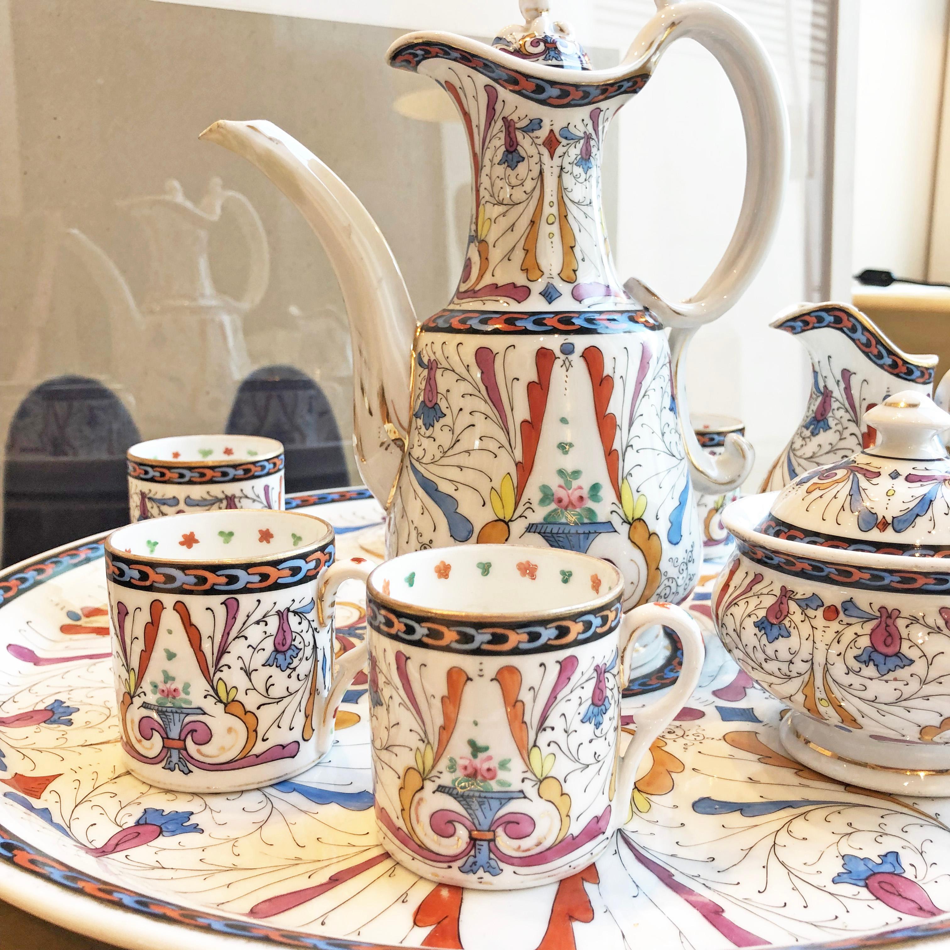 Hand painted Arabian style tea set from the end of 1800s featuring a set of 5 tea cups, tea pot, milk jar, sugar bowl and a serving plate.

Good antique condition.