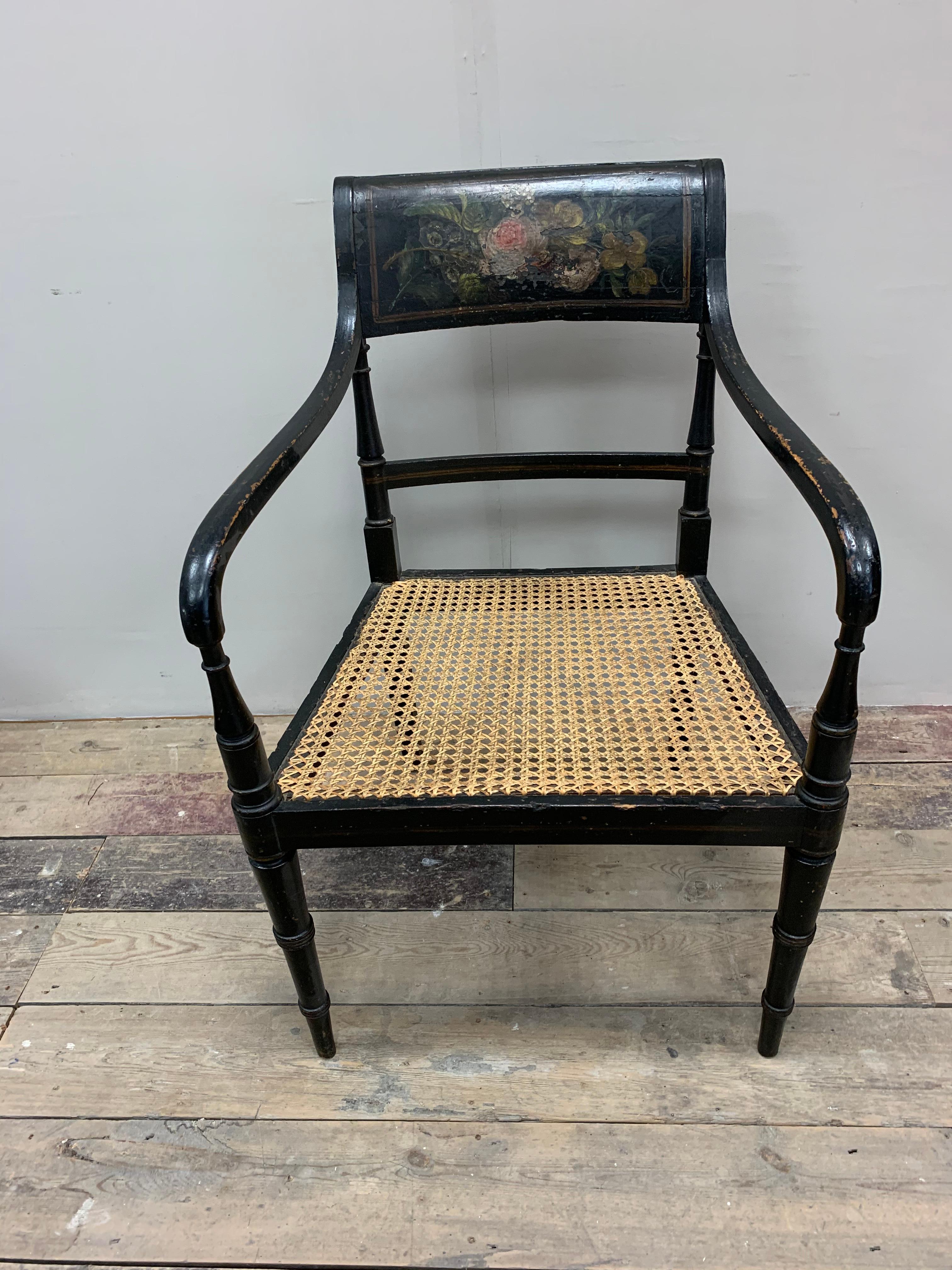 Lovely circa 1830s English black painted open armchair with decorative flower and leaf painted frieze to the back.
The caning to the seat has been redone over time and is in good condition.
A nice size chair and with the addition of a squab