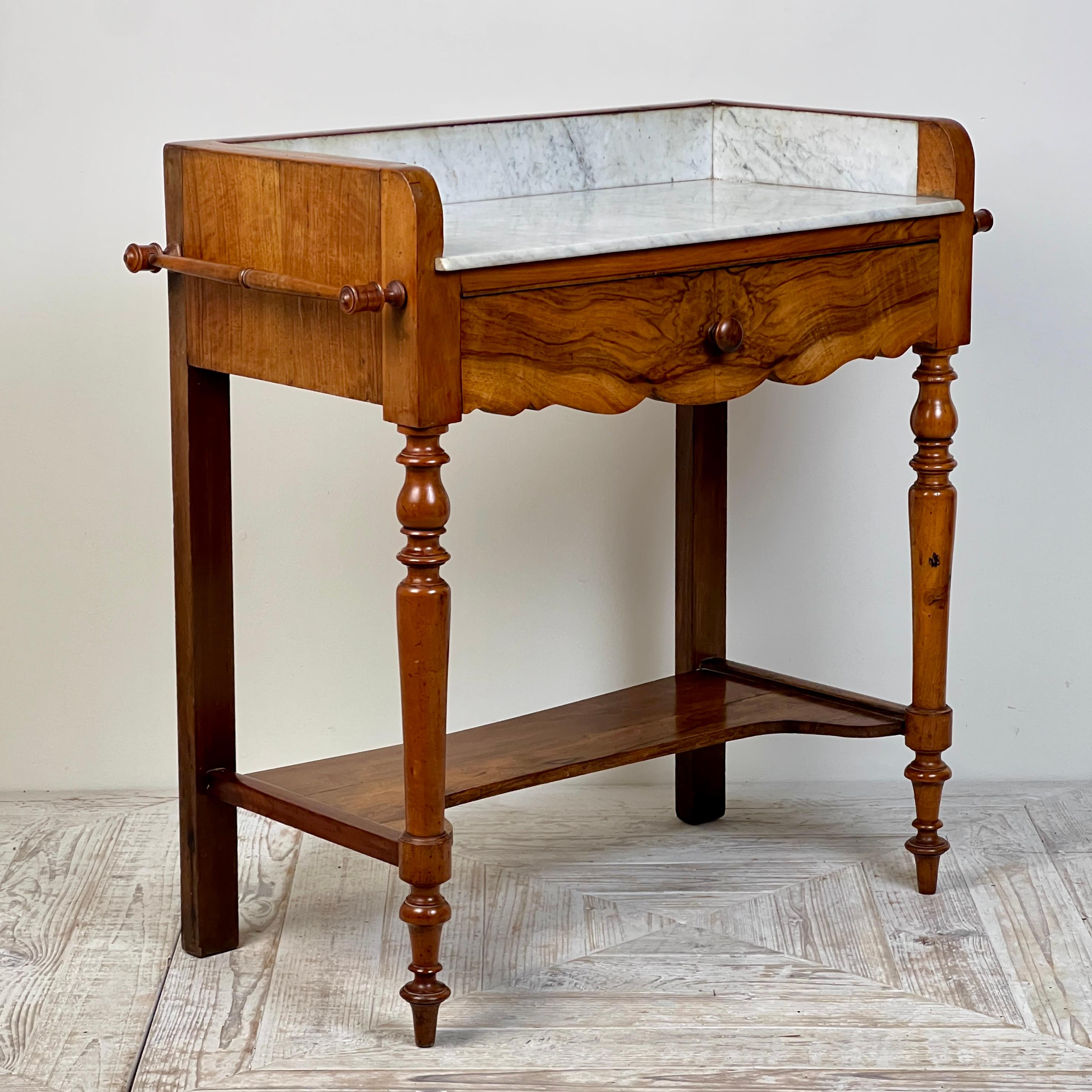 A charming 19th Century French Walnut & Marble Washstand

A rather sweet French 19th-century walnut and marble washstand — simple yet elegant.
This delightful piece features beautifully turned legs, a single drawer with a shaped apron, double towel
