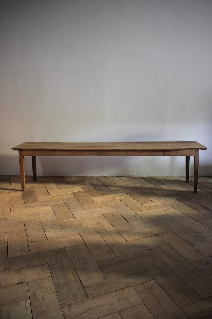 A large 19th century French harvest table from the South of France in its original untouched finish, that will seat 12 people comfortably.
The base is oak with a poplar top.
Additional measurements: 64cm high (Leg room).