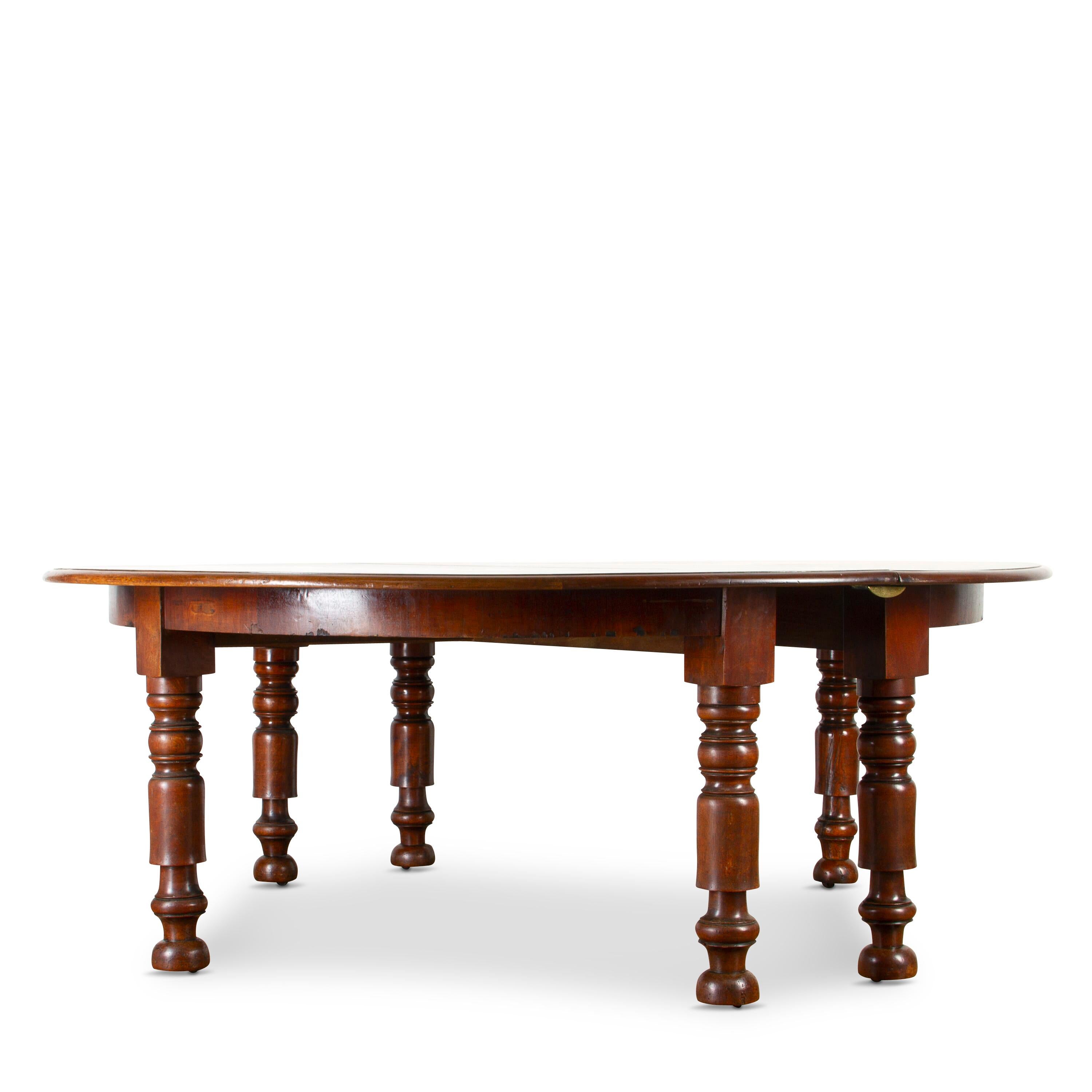 An Impressive early 19th Century French walnut round table. 
The top with moulded edge and raised on substantially turned legs with sunken castors.
It is versatile as it was made to split into two parts so that you are able to create demilune