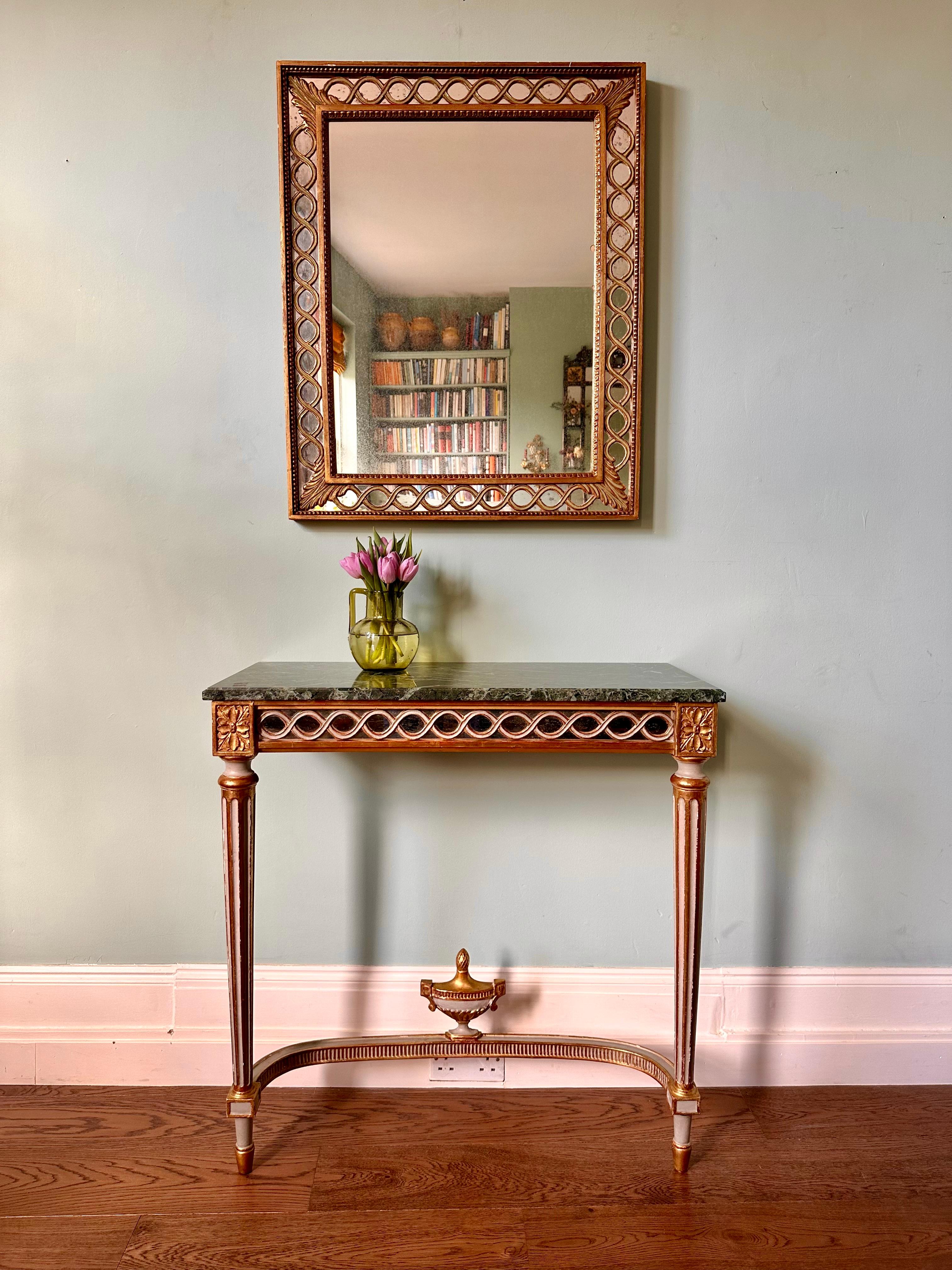 C19th Louis XVI style console and matching mercury mirror.

Superb French console table with Verde Antico marble top, mirrored apron, fluted legs joined by an urn stretcher and beautiful gilded detailing. The matching mirror features just the right