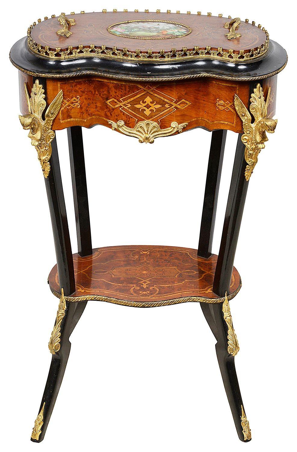 A very good quality late 19th century French marquetry inlaid, ormolu mounted side table / Jardiniere. Having a hand painted porcelain plaque inset to the lid that lifts to reveal a zinc lined plant holder. Winged Griffen mounts, above an inlaid
