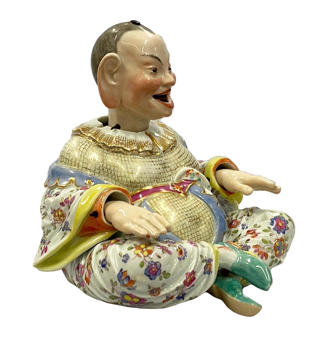 A very good quality late 19th century Meissen porcelain pagoda with nodding head and hands, having wonderful bold hand painted colors with gilded and floral decoration. Measures: 7.5