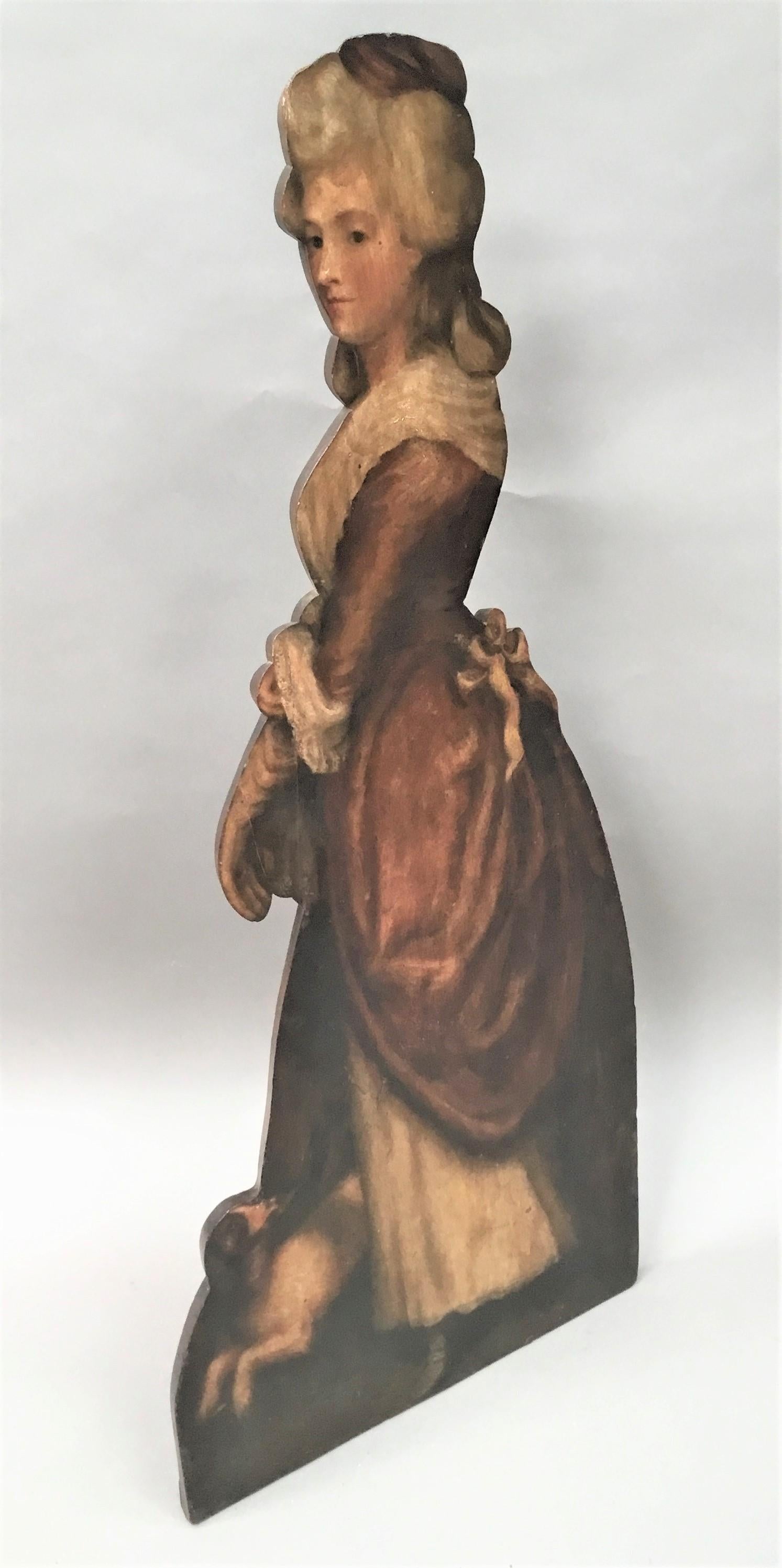 19th century painted dummy board; of a young lady standing in a full length pink and white silk dress with her small brown and white dog at her feet looking up at her. Made in mahogany retaining the original paint.
English circa 1880
Good