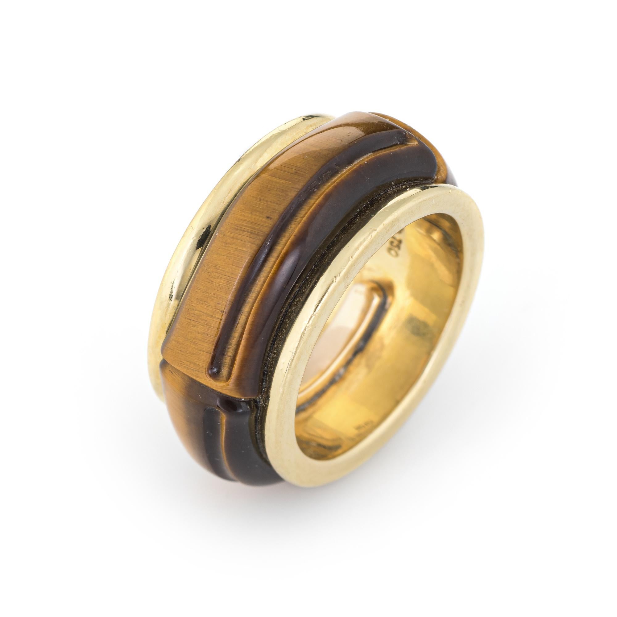 Finely detailed pre-owned Tiffany & Co tigers eye band, crafted in 18 karat yellow gold. 

Tigers eye is carved in a bamboo design and measures 9mm wide. The tigers eye is in excellent condition and free of cracks or chips.    

The ring is designed