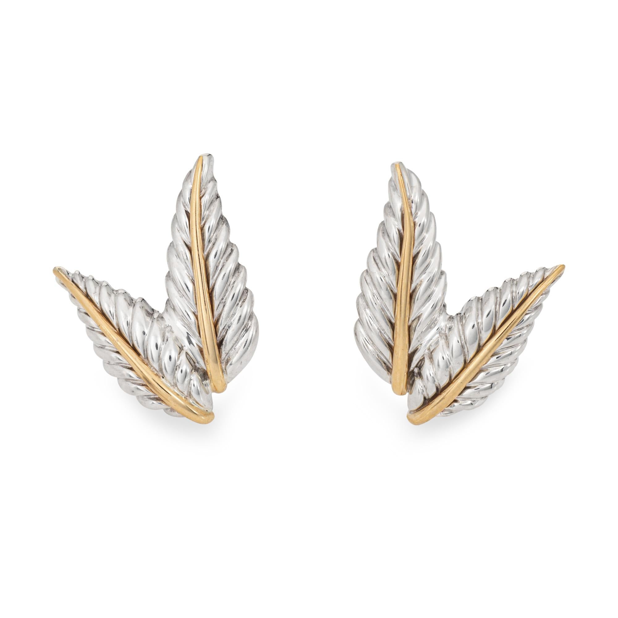 Finely detailed pair of vintage Tiffany & Co leaf earrings crafted in sterling silver and 18k yellow gold (circa 2003). 

Crafted in a two leaf design the earrings highlight a vein of 18k yellow gold to the center with sterling silver leaves. Great