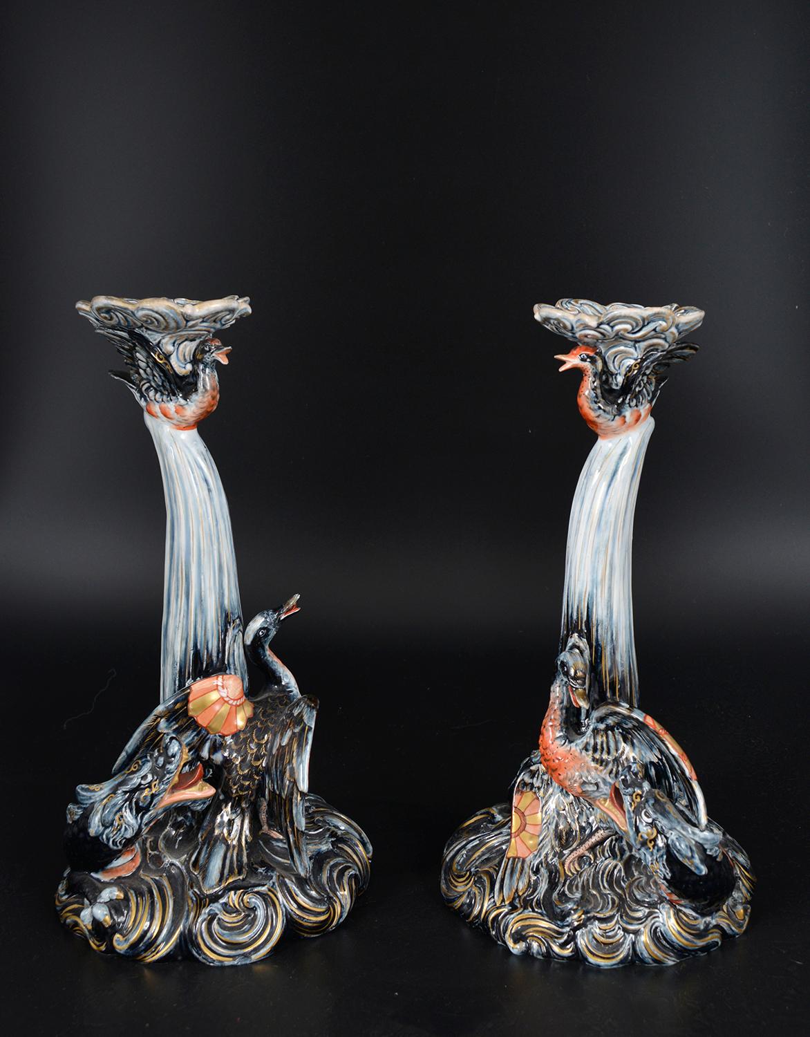An outrageous pair of highly decorative French ceramic glazed pottery candlesticks by Keller & Guérin - the bases in the form of a sea dragon pursuing a bird. Japanese style signature Keller Et Guerin monogrammed to both bases. 
The Lunéville