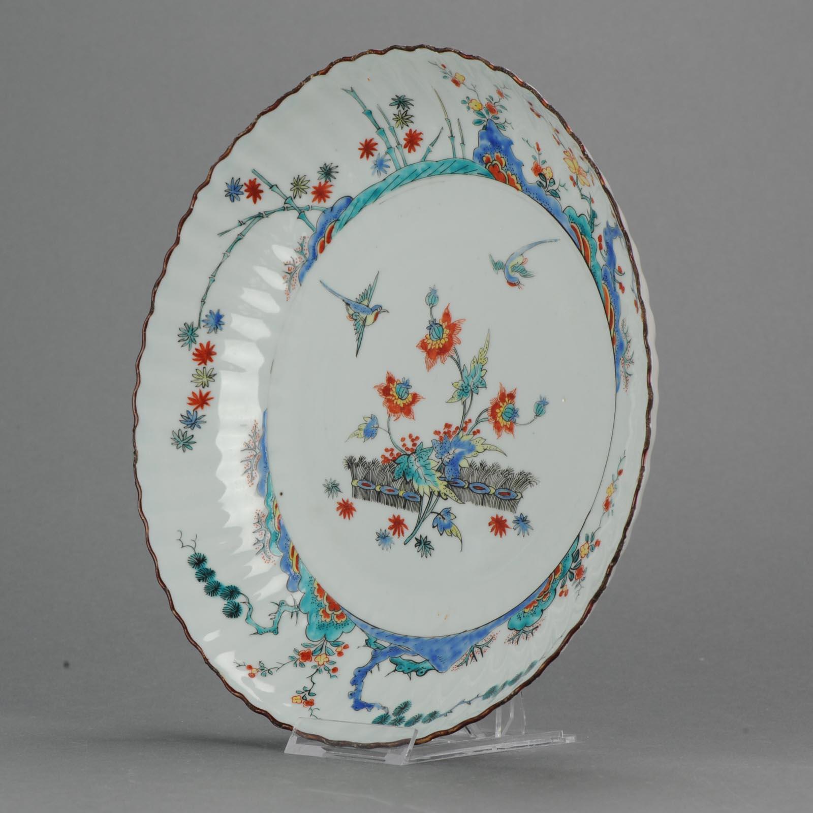 Stunning piece. Decorated in Holland 1720-1730 in Kakiemon style with a border of the' Three Friends' surrounding exotic flowers and banded hedges.

The scene and quality of painting is amazing.

Reference:
Helen Espir, European decoration on