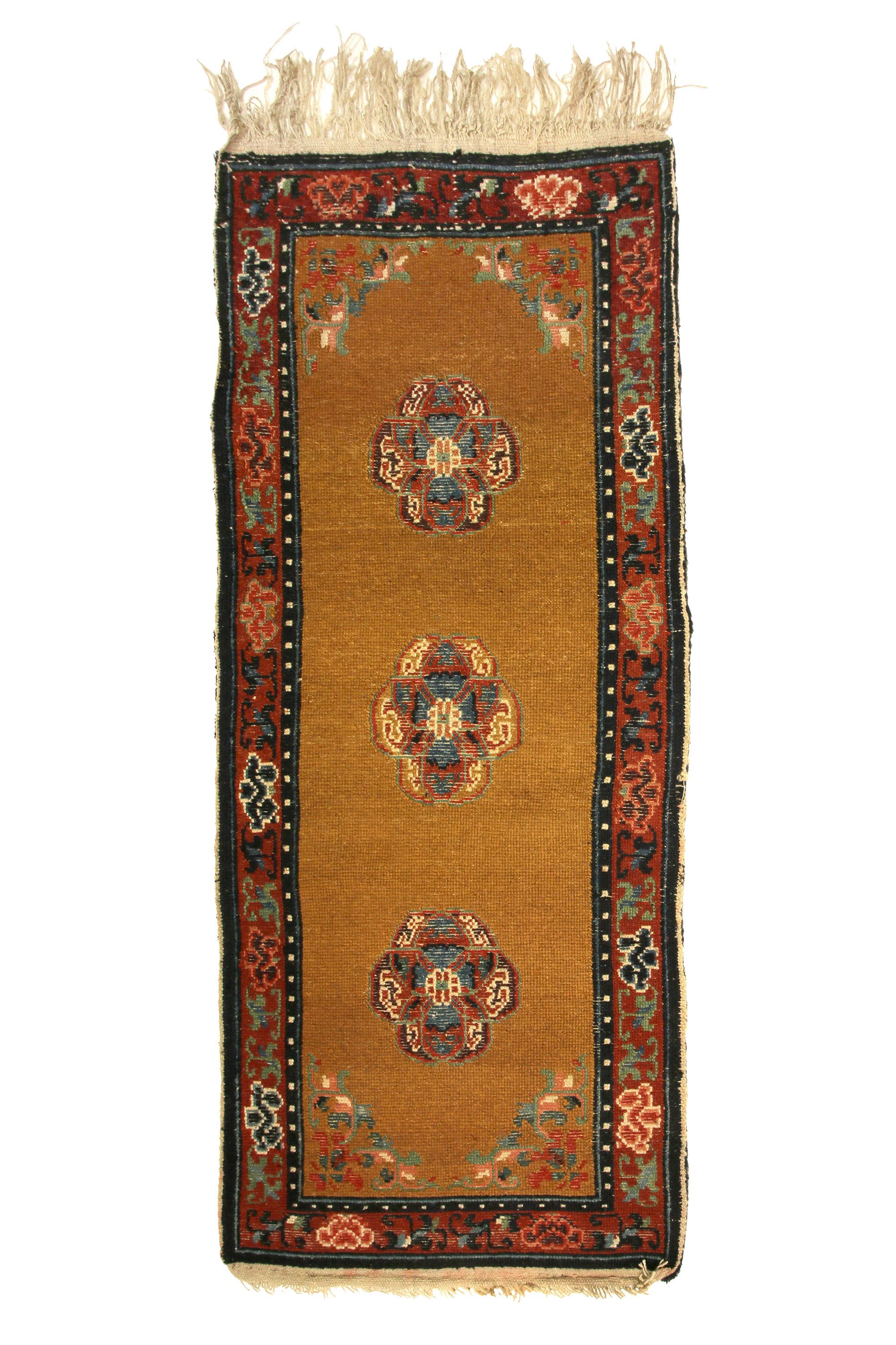 Tibetan sleeping carpet (Khaden)
With medallions composed from clusters of the inedible and sacred Lumpang fruit. The Lumpang symbolizes happiness and longevity thus carpet was originally woven with the purpose of inferring these qualities upon the