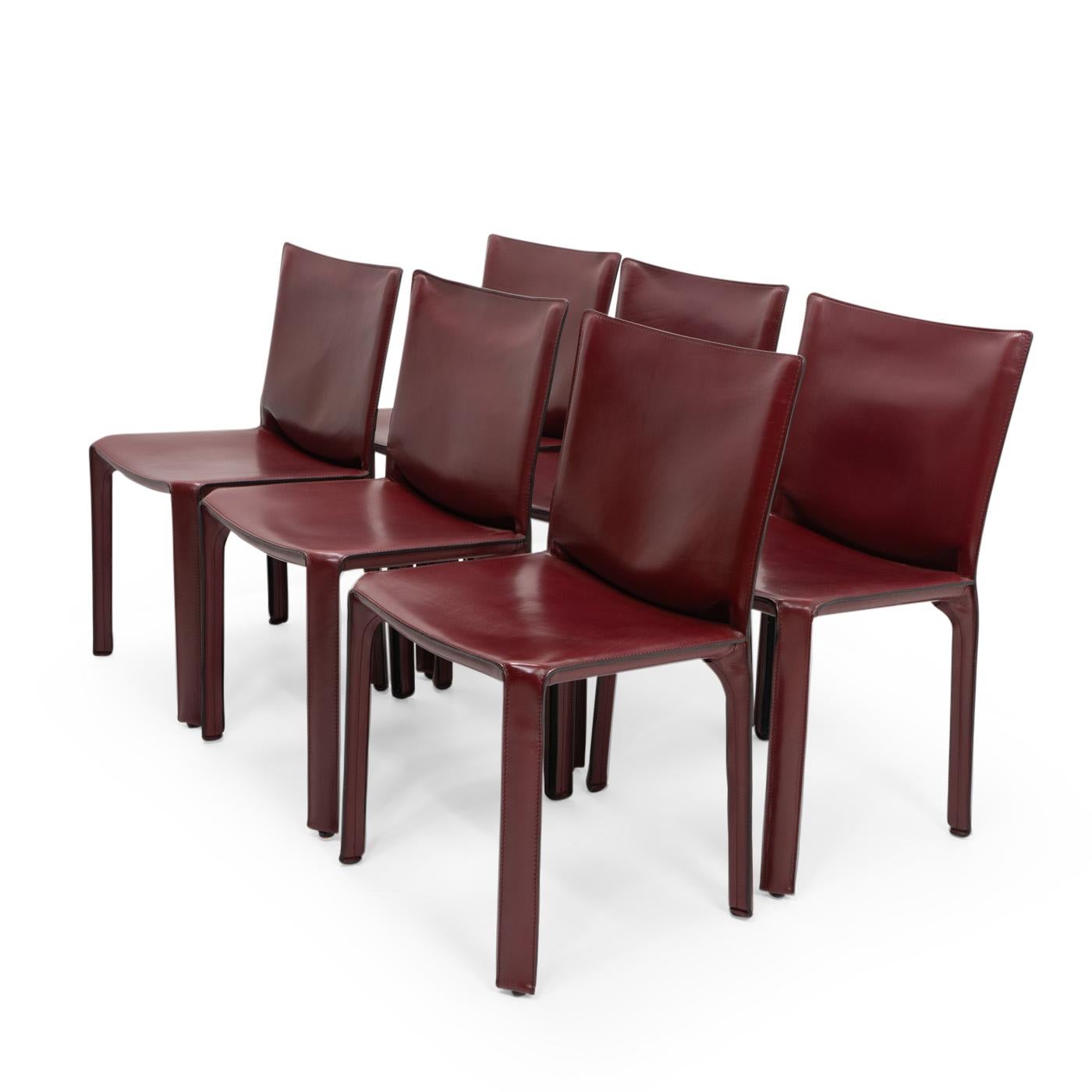 Set of six Cab 412 side chairs in bordeaux red leather by Mario Bellini for Cassina.

The Cab chair is built up as a tubular frame over which thick saddle leather is fitted; the leather skin is kept in place with zippers on the inside legs.

A
