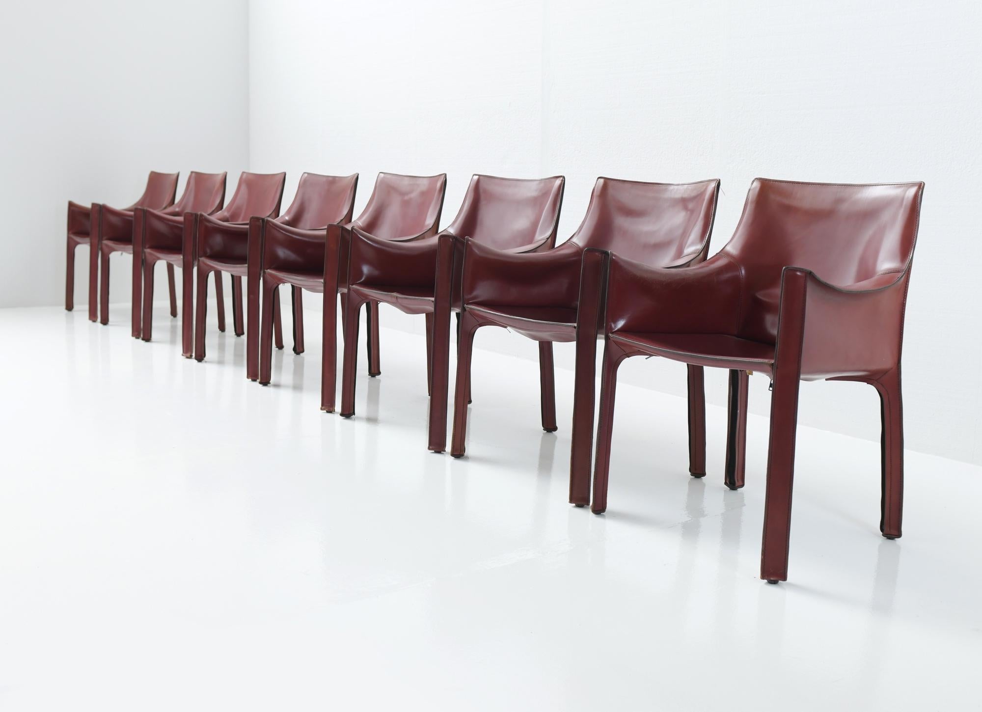 Early edition with stunning patina! 
Set of 9 matching armchairs in Burgundy red!!
Leather upholstery zippered over the frame. The chair is now part of the permanent collection at the New York MoMA. 

Correct vintage condition. No damage.