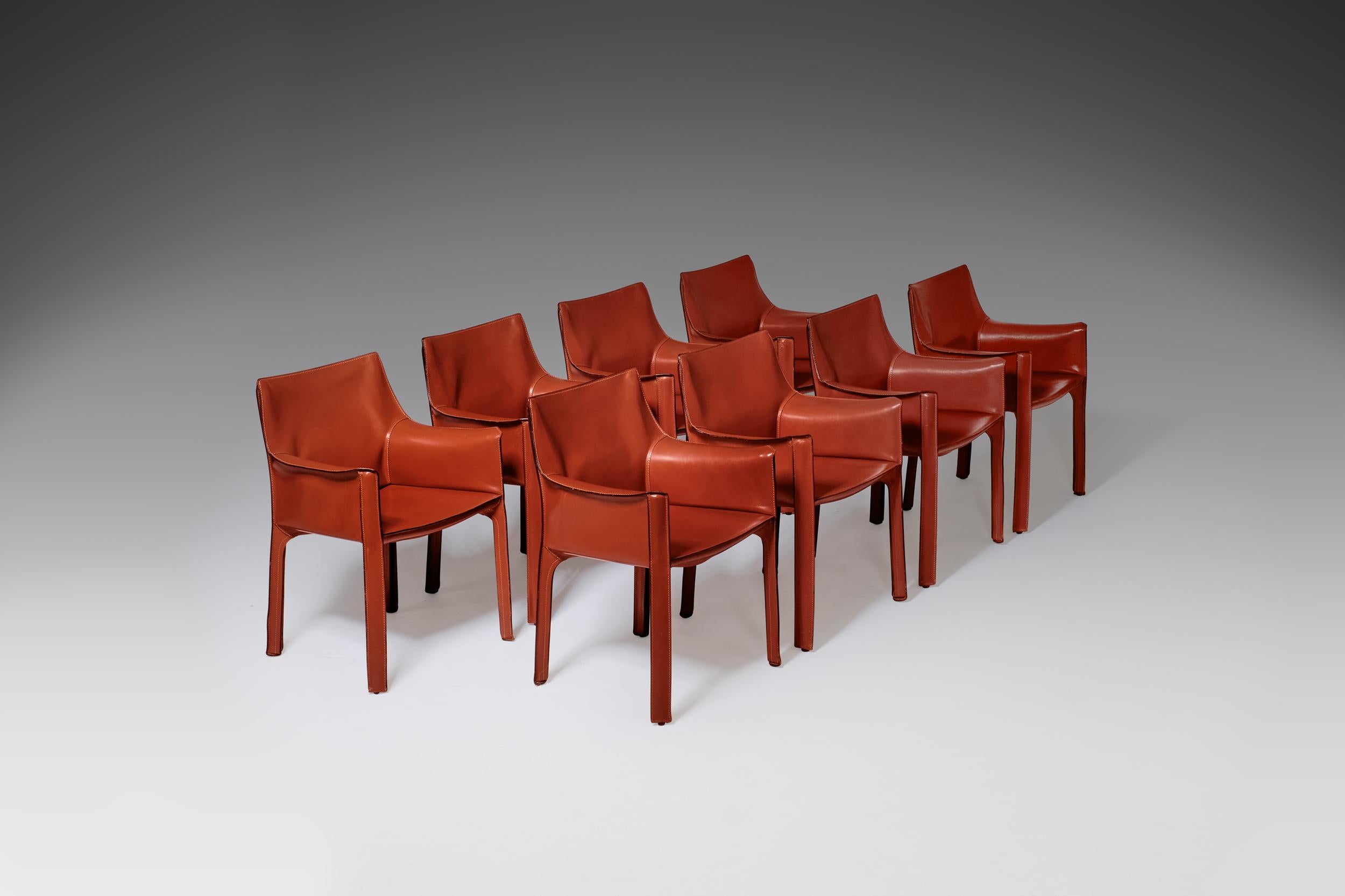 Large set of eight '413-Cab Armchairs' by Mario Bellini for Cassina, Italy, 1977. Very iconic design.
The chairs consists a minimalistic steel frame which is completely wrapped by high-quality cognac / red colored leather. Extremely comfortable