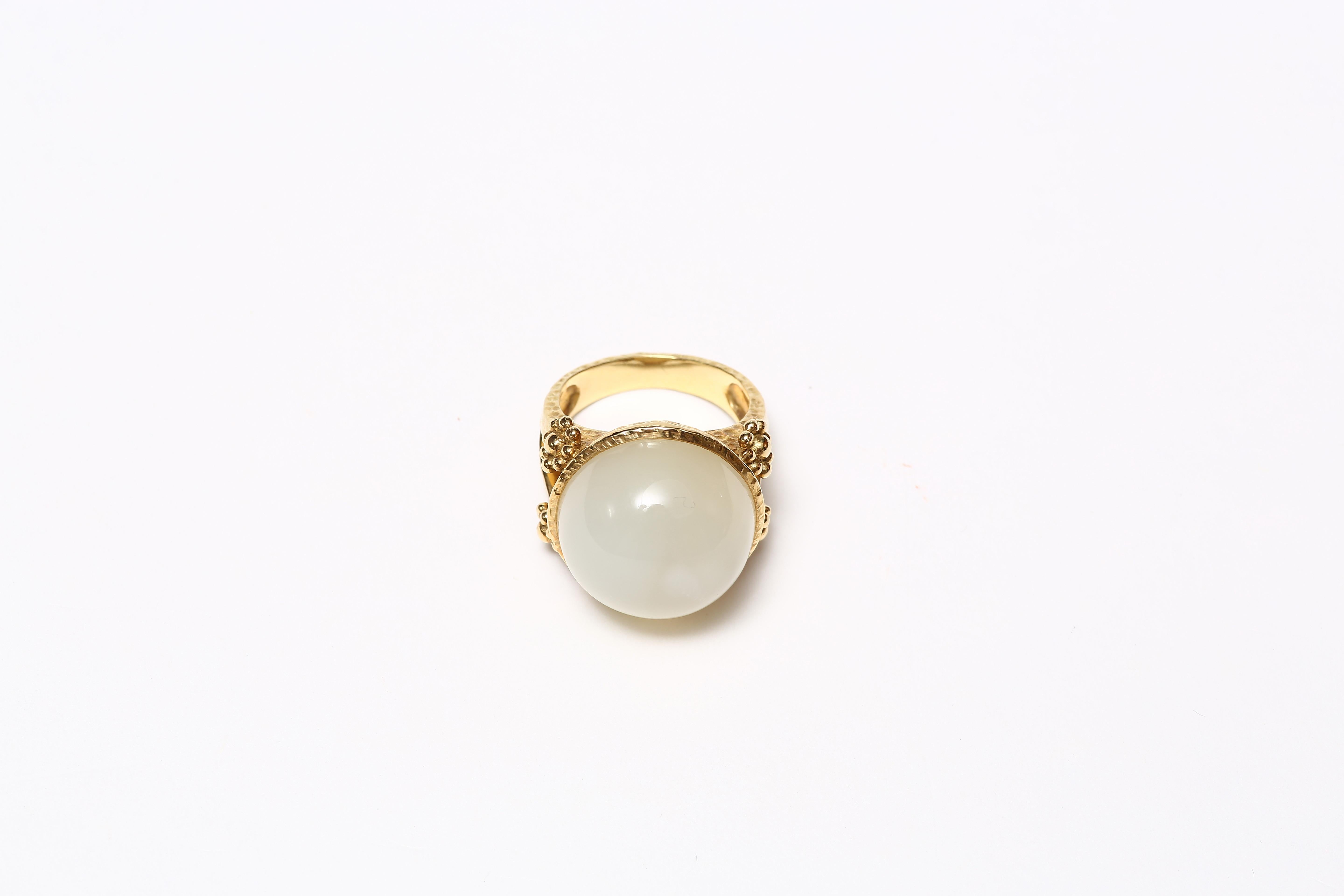 A fabulous ring with a fine large round cabochon moonstone set in solid 18 karat gold with double floral motif on either side .  
US size: 7.5
Interior: 1.7cm dia

Designed by AMANDA CLARK for Altfield, our collection focuses on natures most lovely