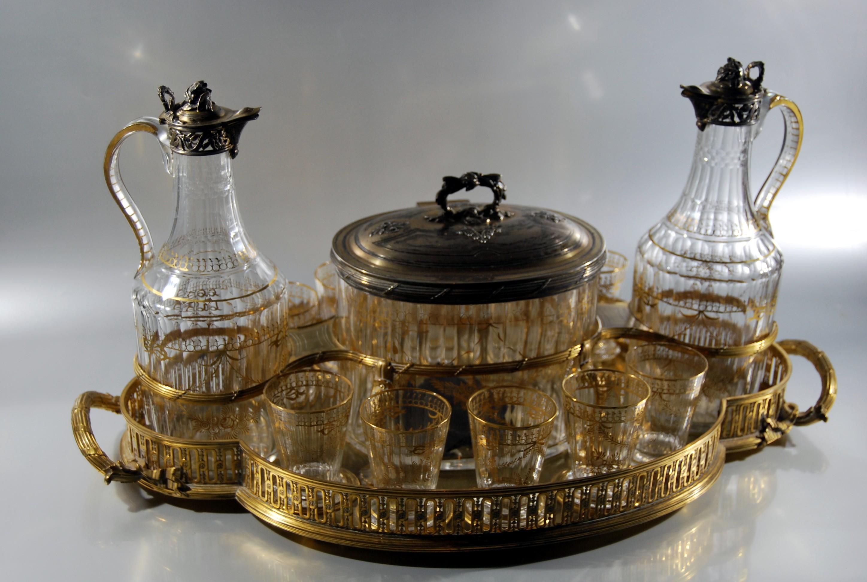 Rare cabaret centerpiece for aperitif, tea or wine in gilt cut glass attributed to Daum with vermeil mount on openwork gilt bronze tray (circa 1891)
The tray dimensions : 19 2/8 x 11 2/8 in
The mounts of the pitchers and the biscuit tin in vermeil
