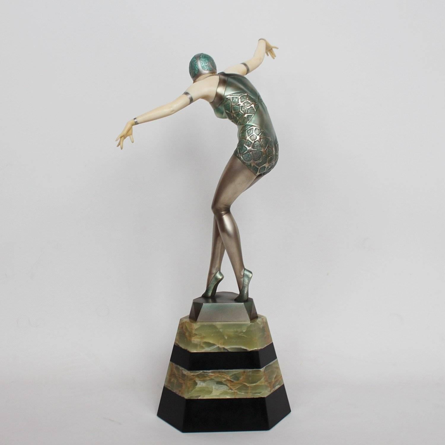 Cabaret dancer, a rare Art Deco, cold painted bronze and ivory figure. Shows a beautiful young showgirl in stylised dance pose. Set over a bi-coloured green onyx and black marble plinth. Excellent original condition.

Literature: Alberto Shayo,