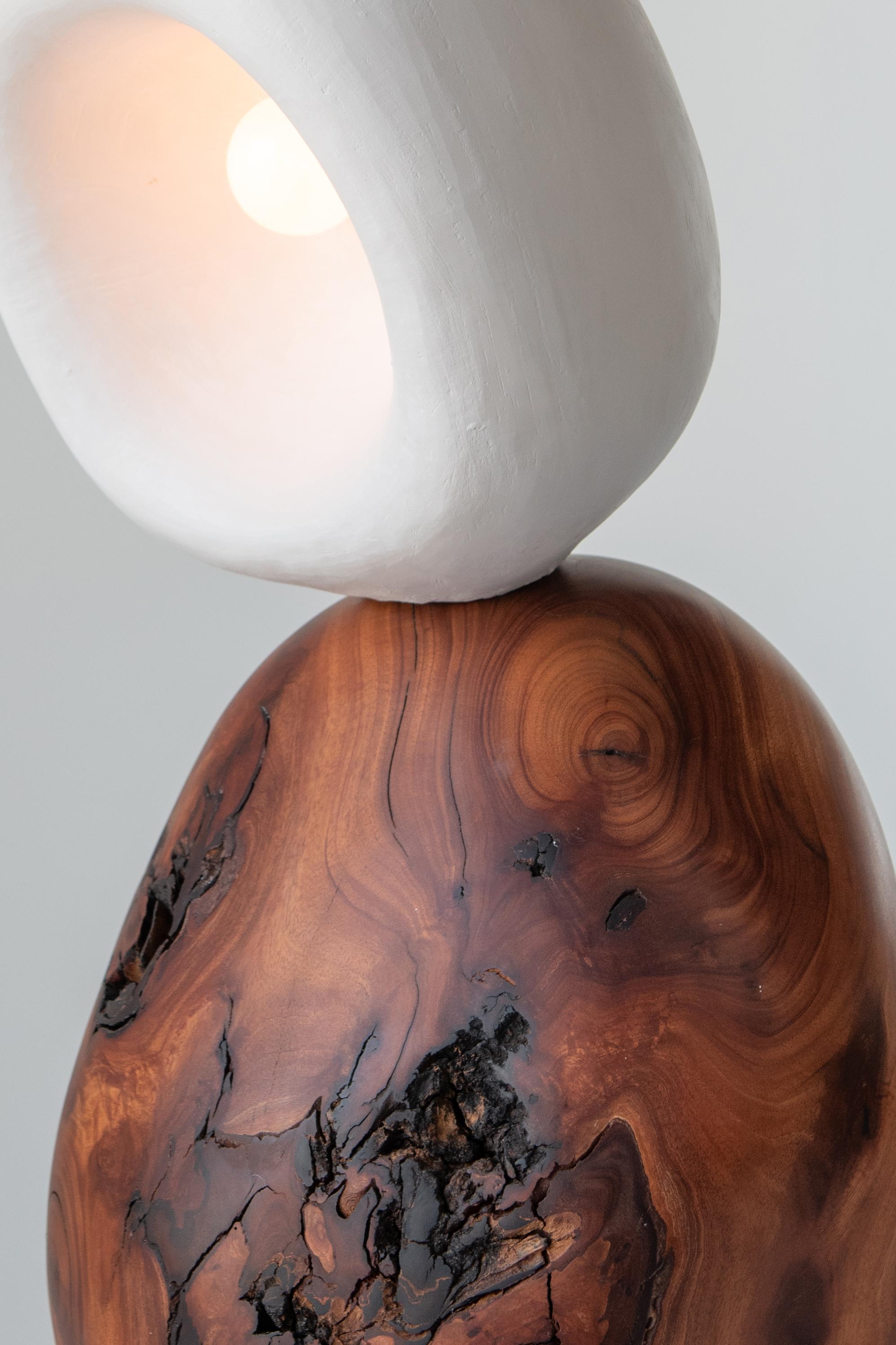 Hand carved from solid mahogany wood and polished gypsum plaster, he flawless confluence of elements makes for a truly unique table lamp.