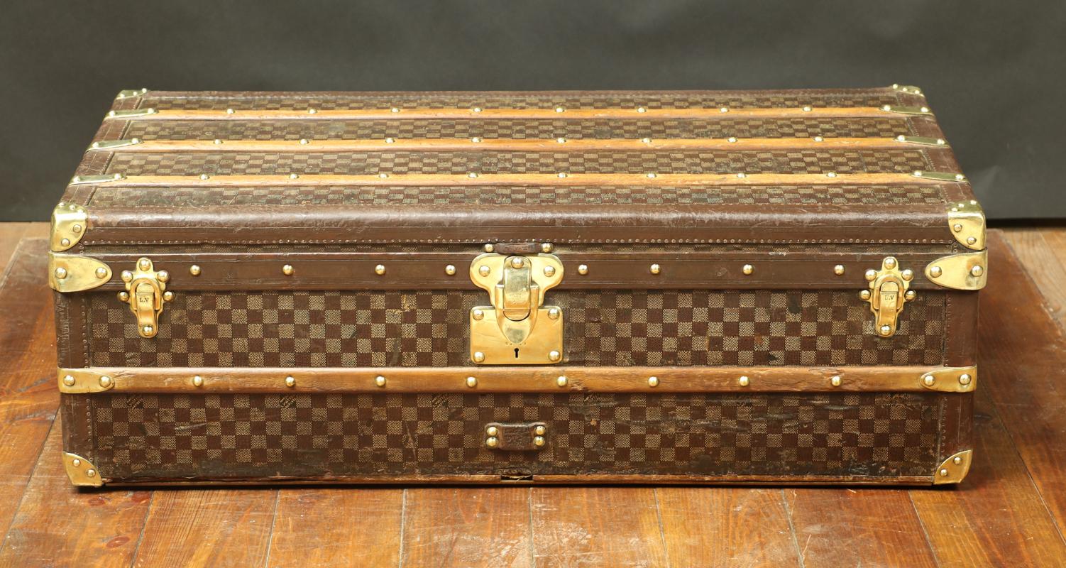 Louis Vuitton squarres trunk 
1st series 
Leather borders 
Interior redone 
Lock and clasps in solid brass 
1 slat from below has been changed
The cabin trunks were designed to be slipped under the bed in the liner cabin, that's why the height