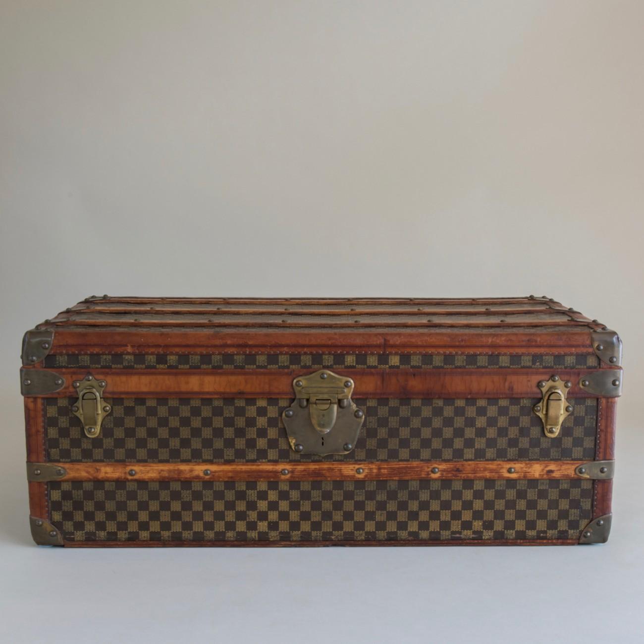 A charming cabin trunk in a checkerboard pattern canvas by French maker, Paul Romand, 213 Rue St Honore´, Paris. With leather trim, exceptional brass fittings and original interior lining, circa 1900.

Dimensions: 92 cm /36 inches (length) x 53.5