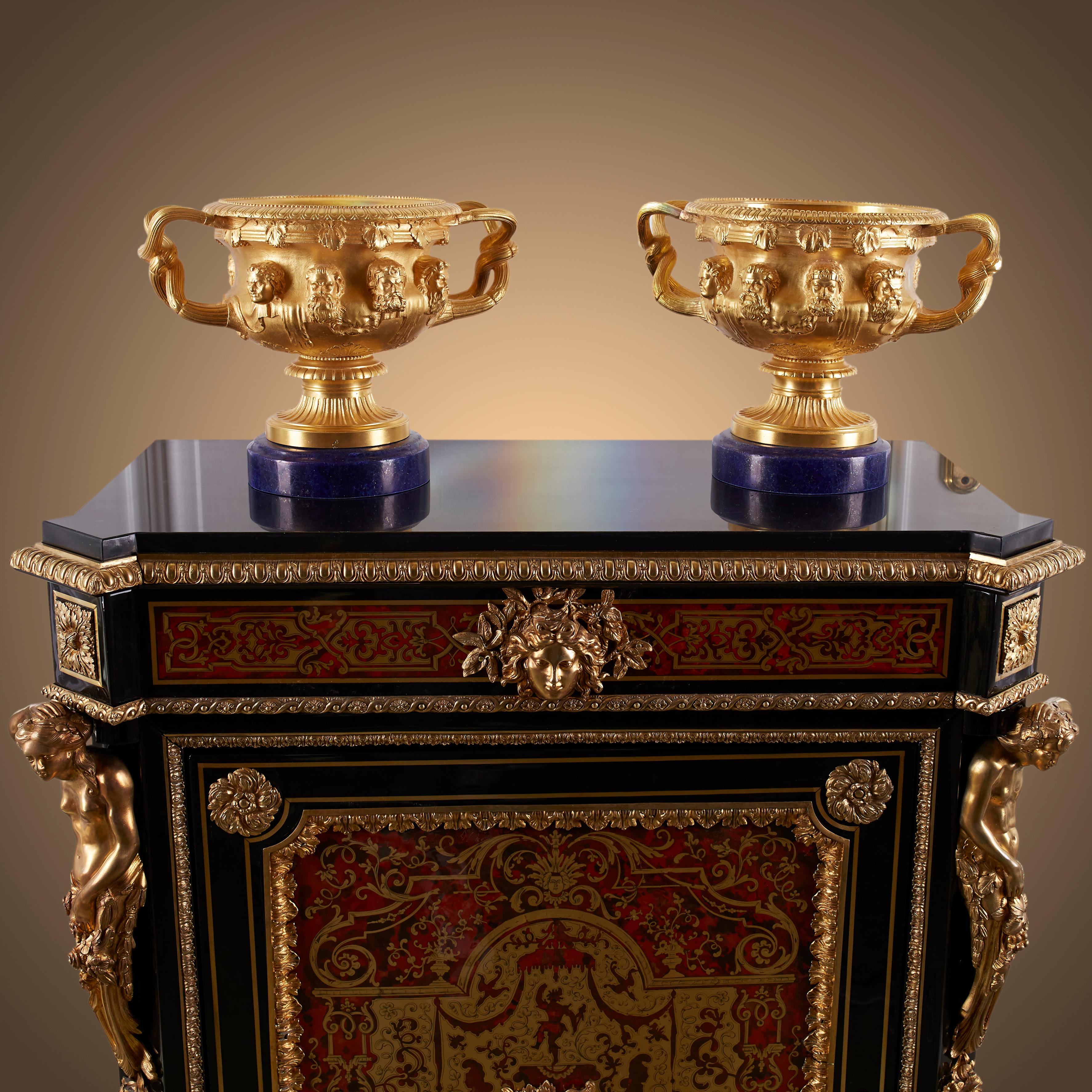 This wooden cabinet is designed in the Boulle style. This style was very popular around the time of Napoleon III. The characteristic of this style is the use of small pieces of wood in furniture, inlaid designs with many different materials: