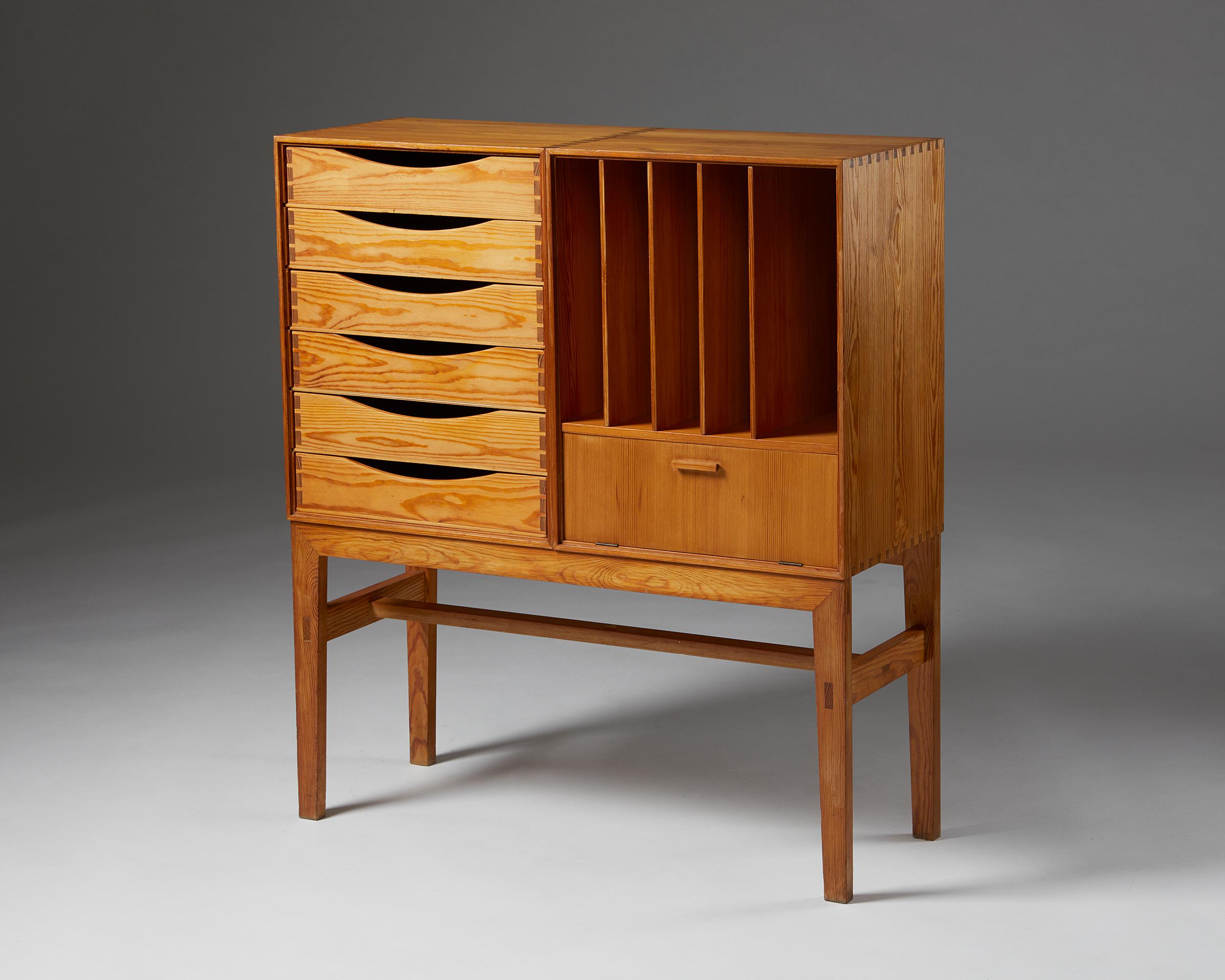 Cabinet, anonymous,
Denmark, 1950s.

Oregon pine. 

This charming piece is an exquisite example of Danish cabinetmaking. The visible corner joints and the stretcher’s through mortise and tenon joints show unparalleled craftsmanship. Scandinavian