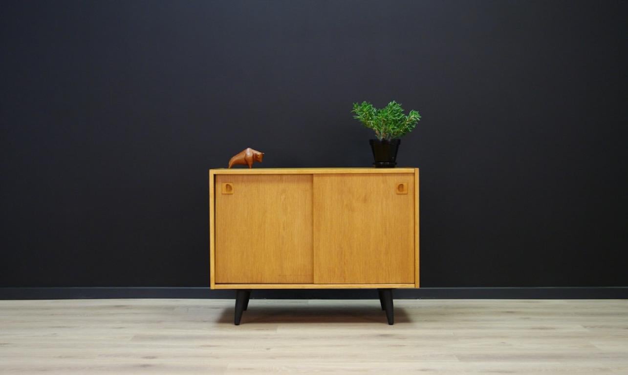 A remarkable cabinet from the 1960s - Danish design, finished with ash veneer, spacious interior, behind a sliding door, it has a black shelf. All preserved in good condition. Product might show slight traces of use (small scratches are visible,