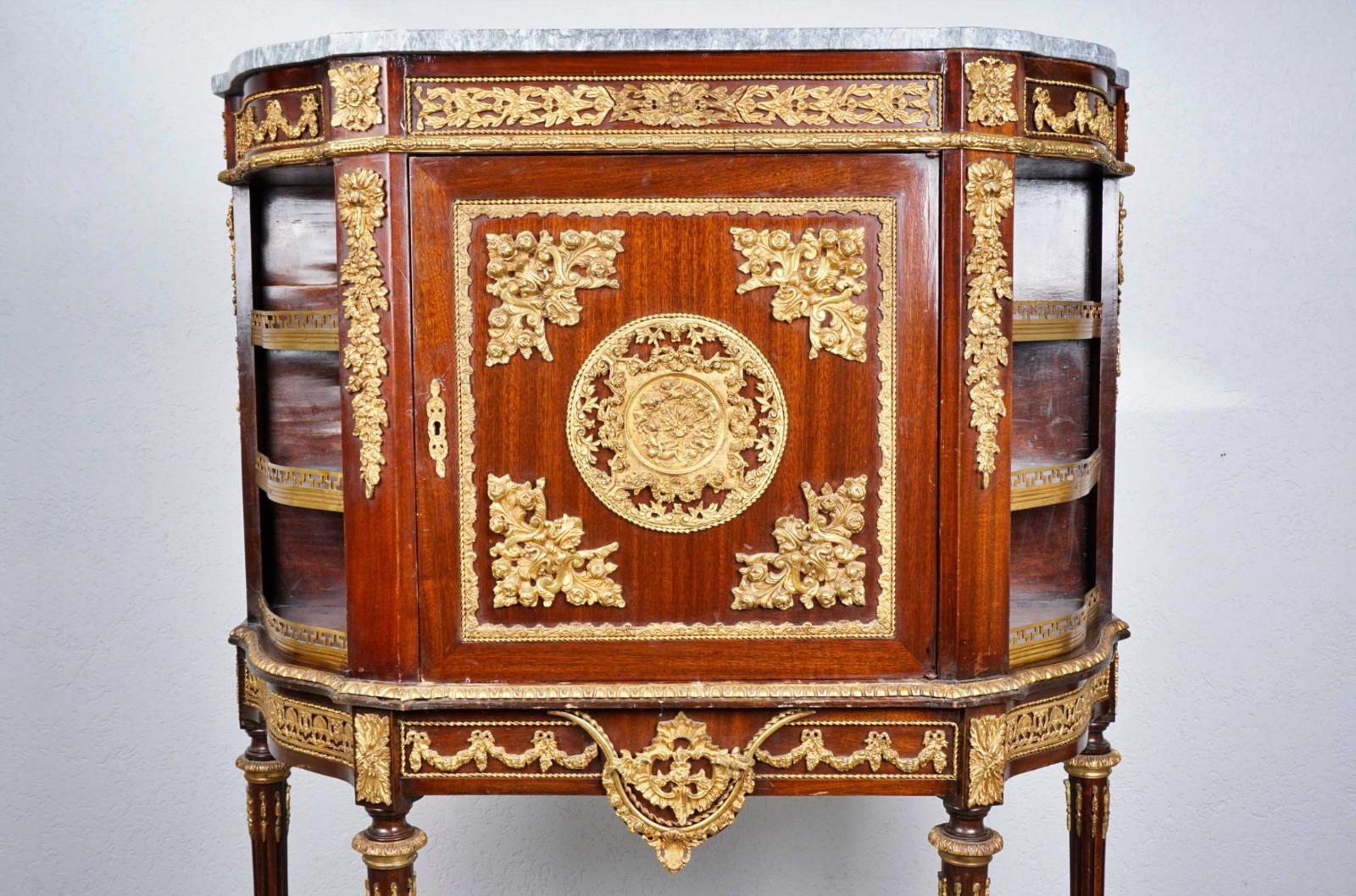 Cabinet / buffet France 19th century Napoleon III

mahogany veneer, gilded bronze appliqués, rich flower and leaf decoration with girlade and rosettes, central large medallion with cherub scenery, laterally with 3 compartments each, body hollow,