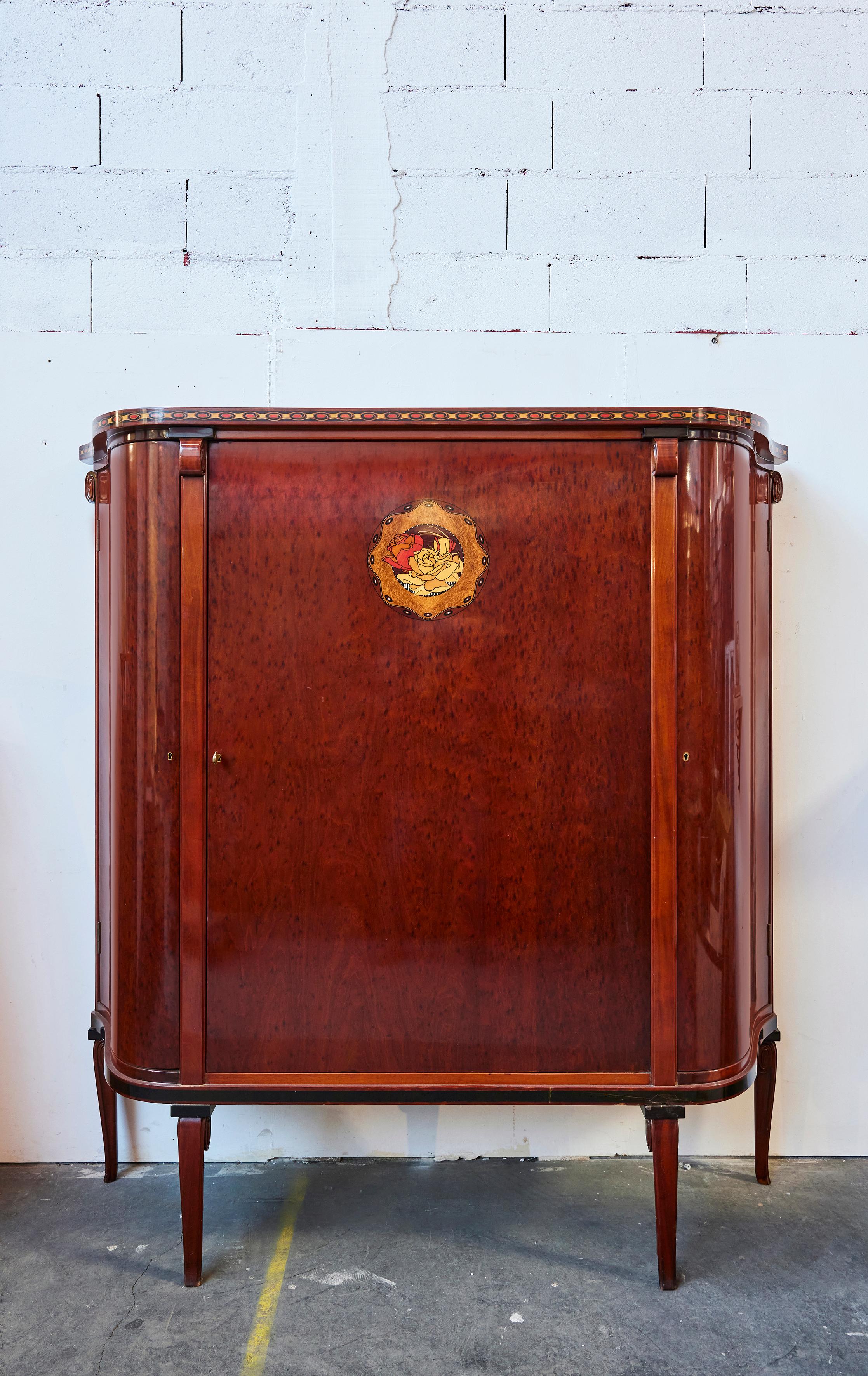 Maurice Dufrêne (1876-1955)
Important 3-door cabinet in pommelé mahogany with wood marquetry and mother-of-pearl decoration
French designer,
Circa 1925,
H: 181 cm D: 50 cm W: 174 cm maximum.

Maurice Dufrêne, a leading figure in early 20th-century