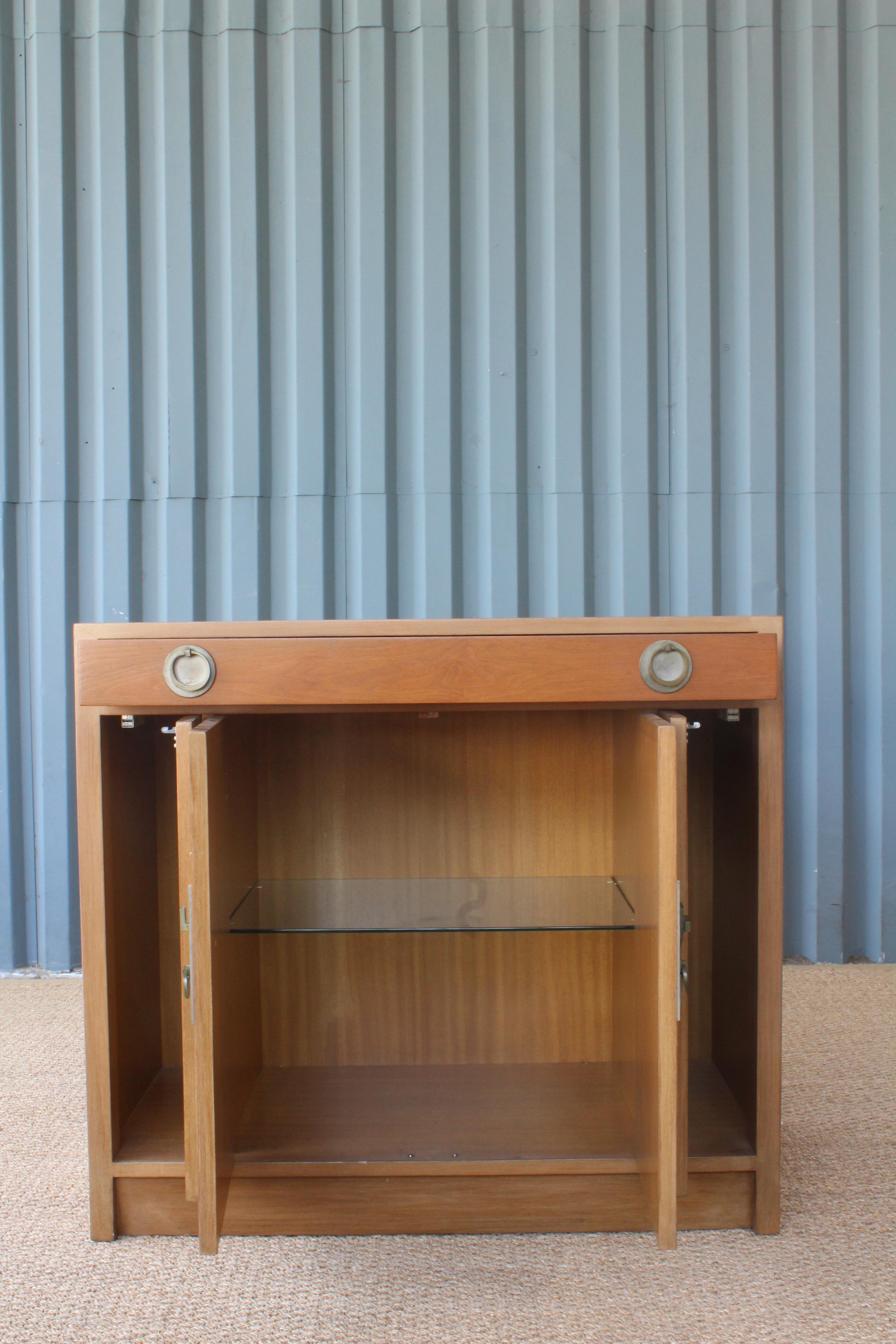 Asian inspired cabinet or dry bar designed by Edward Wormley for Dunbar, 1950s. Wonderful original condition. Includes a top drawer, two side compartments and a centre section with an adjustable glass shelf.