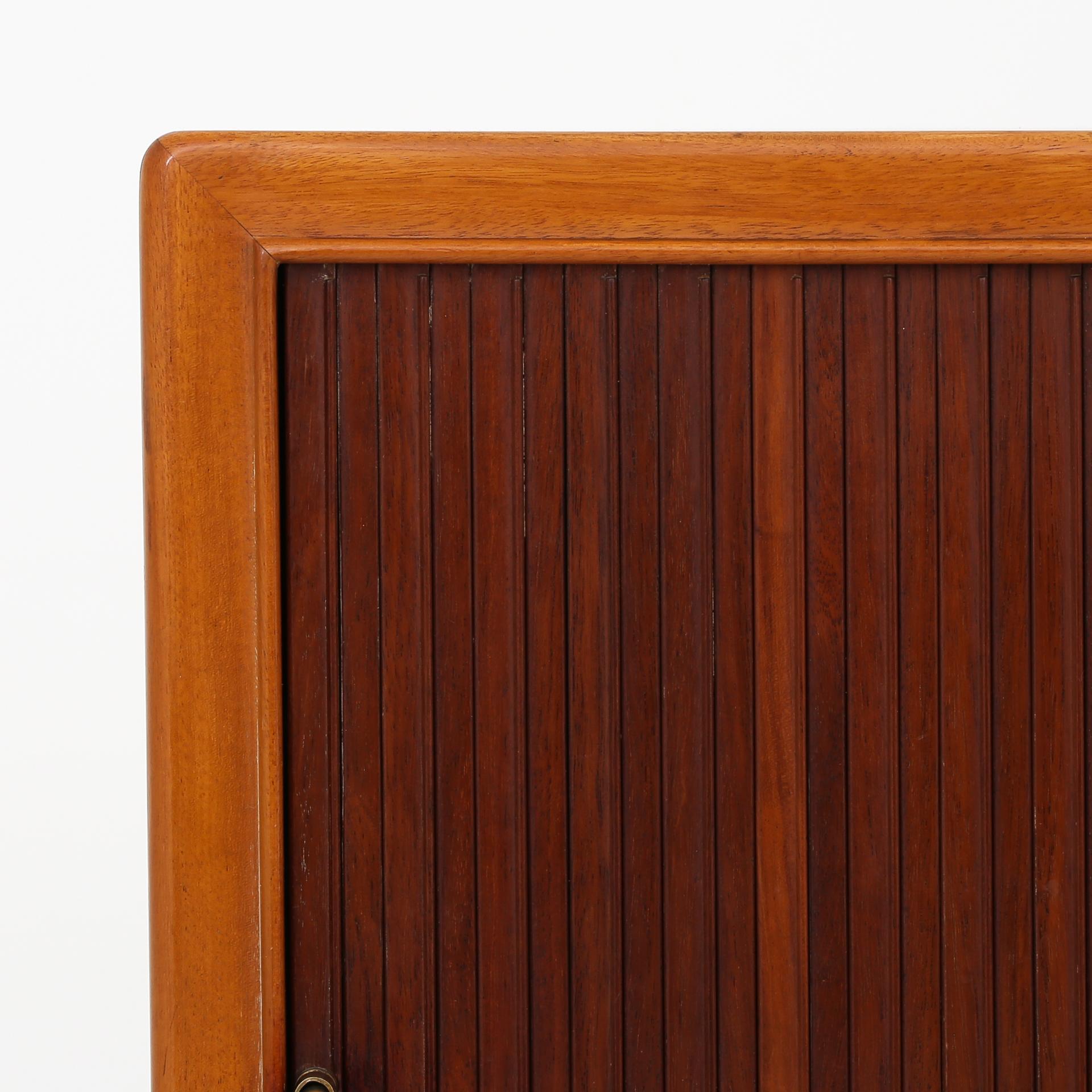Large cabinet in mahogany with tambour doors, drawers and brass hinges. Frits Henningsen