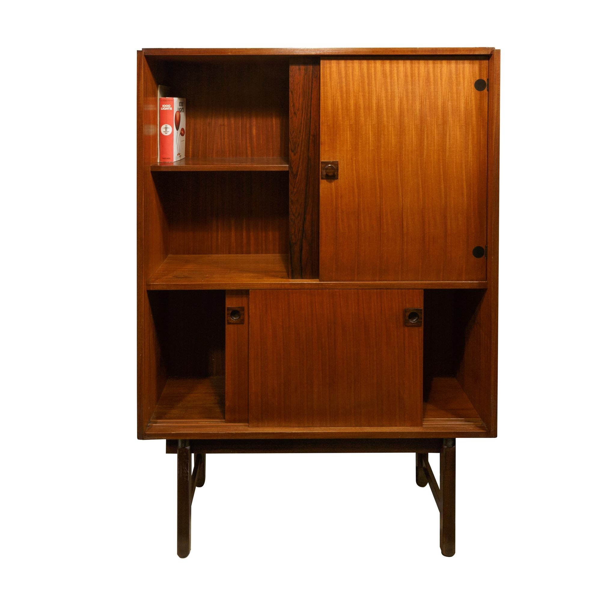Cabinets by Gianfranco Frattini from Mobili Cantu, Italy, 1960s. The cabinet in the upper part has an open compartment and closed part with door. In the lower part two sliding doors. The main feature is the high legs and the round and black finishes