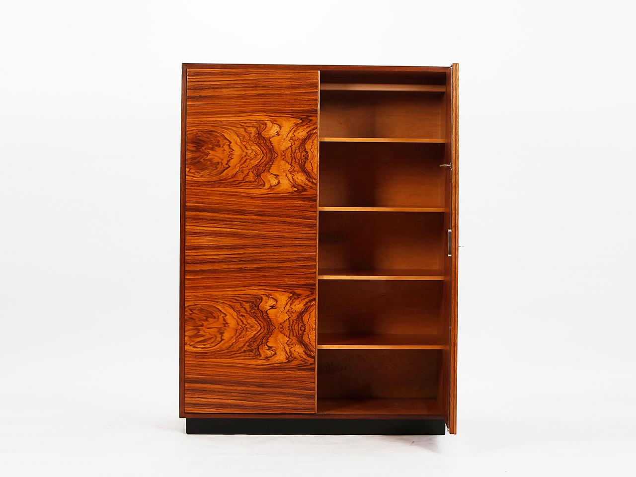 Designed by Jindrich Halabala in the 1930s. Produced by spojene UP Závody in former Czechoslovakia. Features two doors veneered in Caucasian walnut. Oak body. Removable shelves. Restored original condition.
