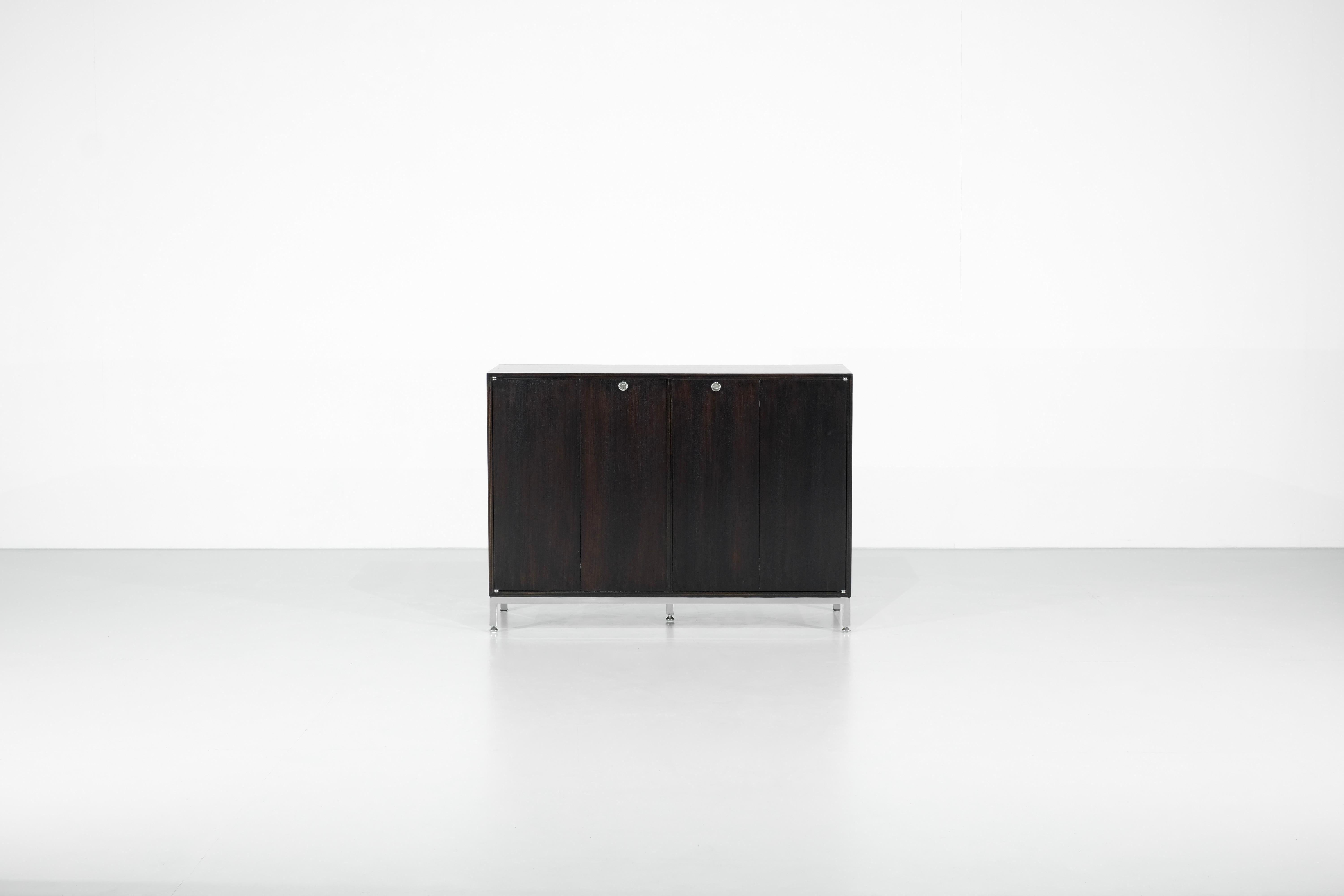 Sideboard Cabinet in wood designed on black metal chromed base, the butterfly doors are nice details, with the key.

Beautiful wood restoration.

Designed by Jules Wabbes for Le Mobilier Universel, Belgium 1960s.

 

Designer - Jules