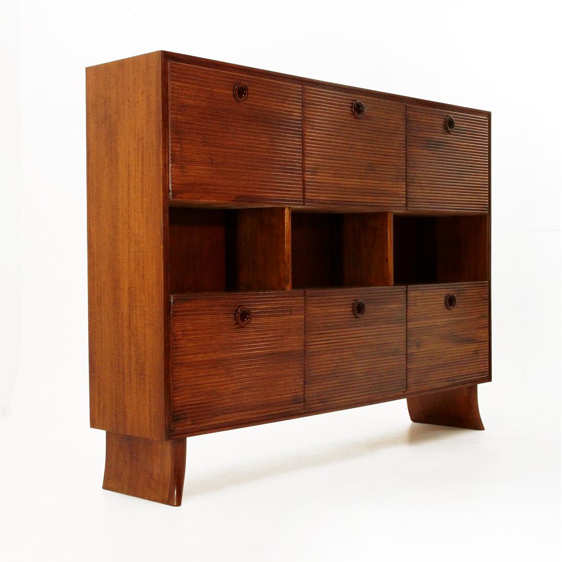 Cabinet designed in the 1930s by Paolo Buffa and executed by Galdino Maspero.
Structure in veneered wood.
3 central open compartments.
6 compartments with front door covered in grissinato wood.
Turned wooden handles with pass-through