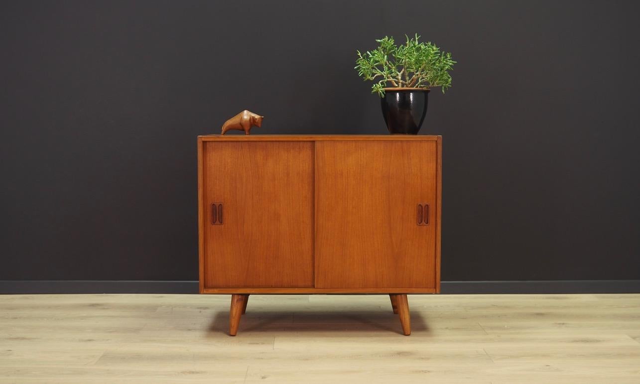 Classic cabinet from the 1960s-1970s. Danish design, Minimalist form. The surface of the furniture finished with teak veneer. Shelf behind a sliding door. Maintained in good condition (minor bruises and scratches) - directly to use.

Dimensions: