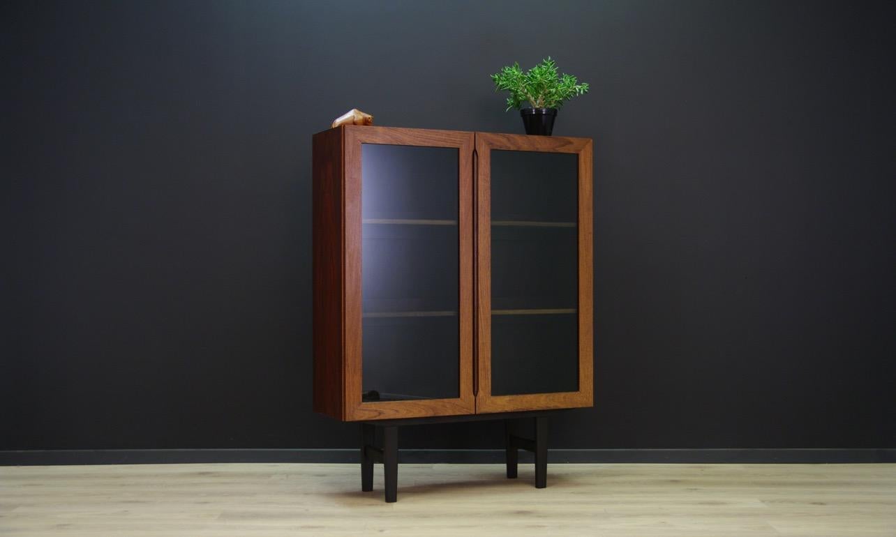 Retro cabinet from the 1960s-1970s, Danish design. The surface is veneered with rosewood. Spacious interior with shelves and lighting behind a glass doors. Adjustable shelves. Preserved in good condition (minor scratches and bruises, one side