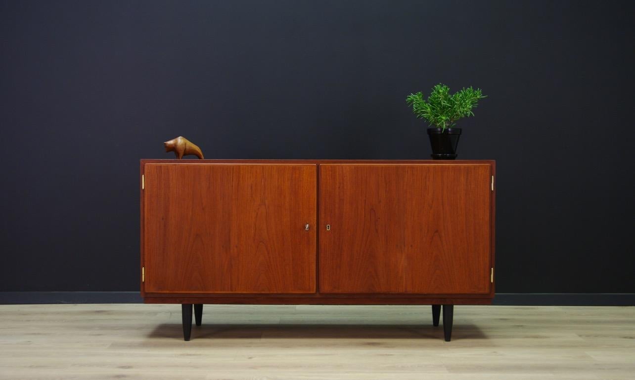 An original cabient from the 1960s-1970s, minimalist form - Danish design. Produced in the Central Møbler manufacture. The form veneered with teak. Roomy interior with adjustable shelves and drawers. It has a key. Preserved in good condition