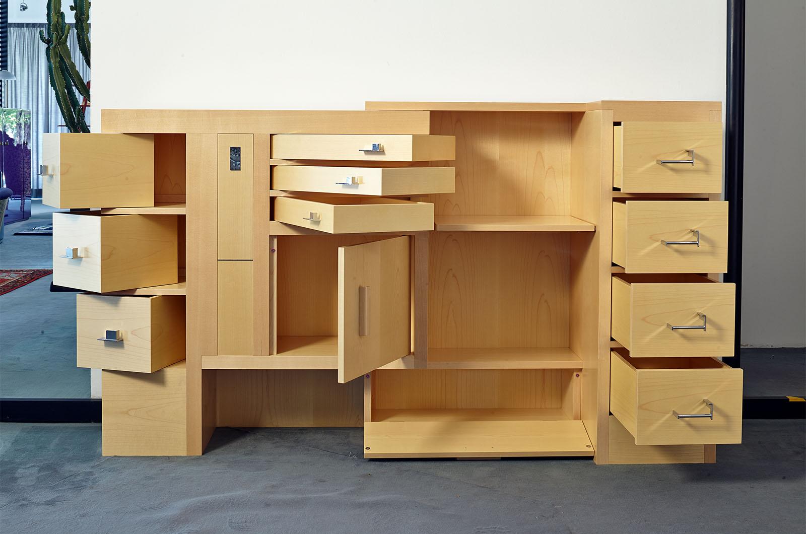 This piece is number 12 of the now closed edition of 25.
The cabinet has several drawers of different sizes for storing tools and documents and has a folding shelf to provide a writing surface.  Tilting or sliding drawers provide the perfect space