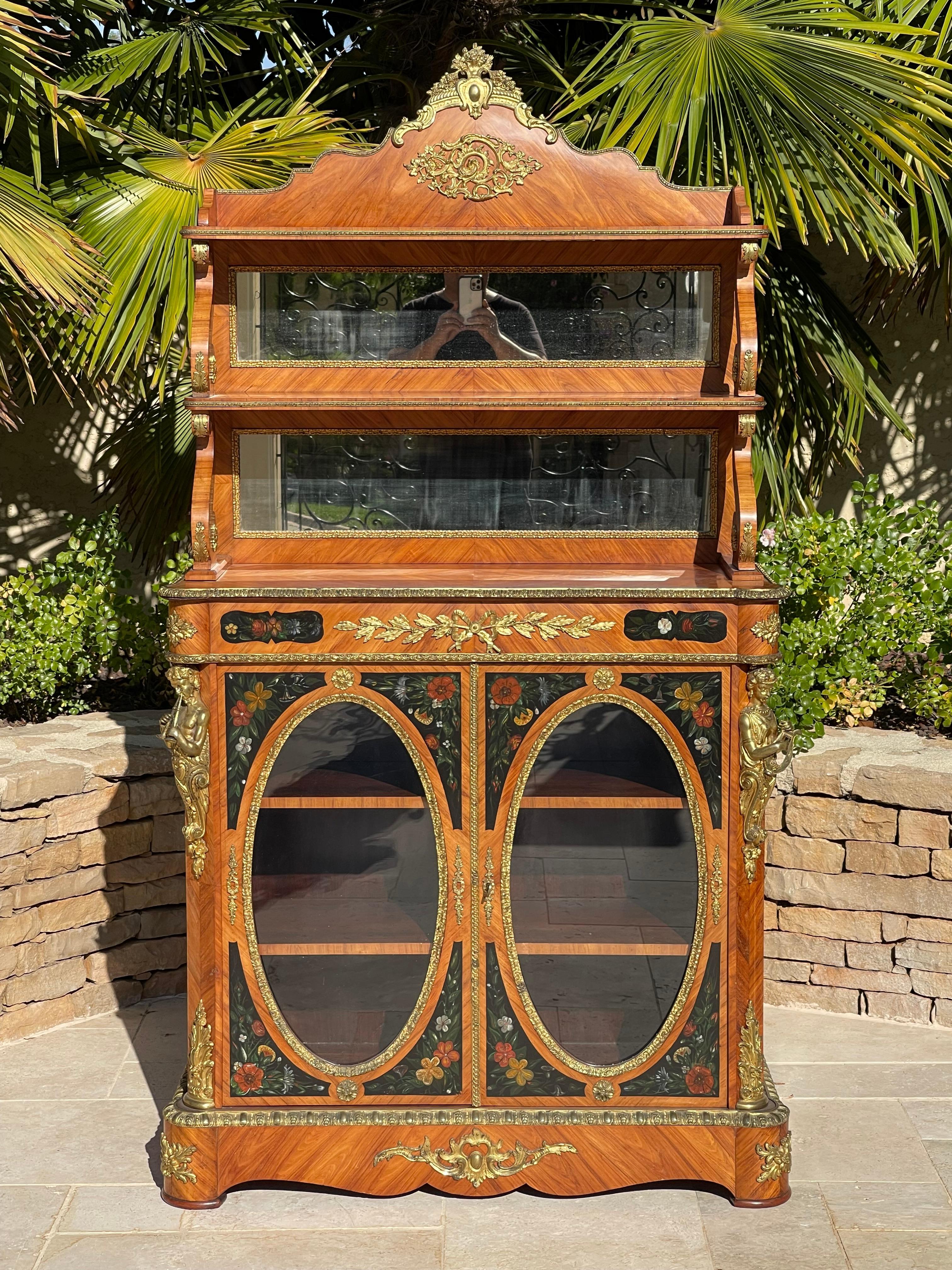 Napoleon III period marquetry and gilt bronze display cabinet. The upper part is composed of two shelves with mirrored backs. The lower part opens with two oval glass doors with 2 shelves inside. This piece of furniture is decorated with chiseled